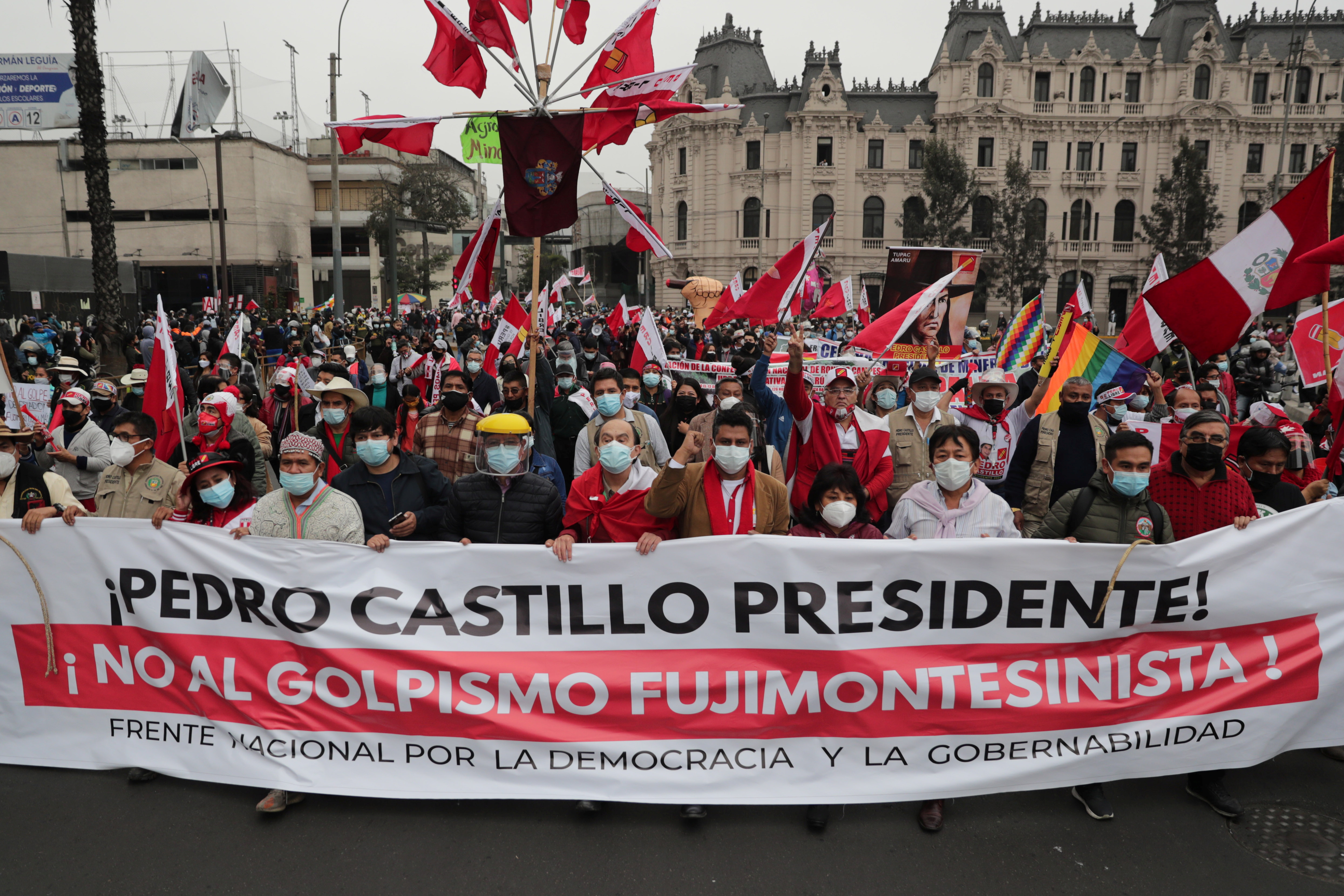 Supporters of Peru's presidential candidate Pedro Castillo hold a banner reading "President Pedro Castillo. No to the Fujimori/Montesinos coup" in Lima, Peru June 26, 2021. REUTERS/Sebastian Castaneda