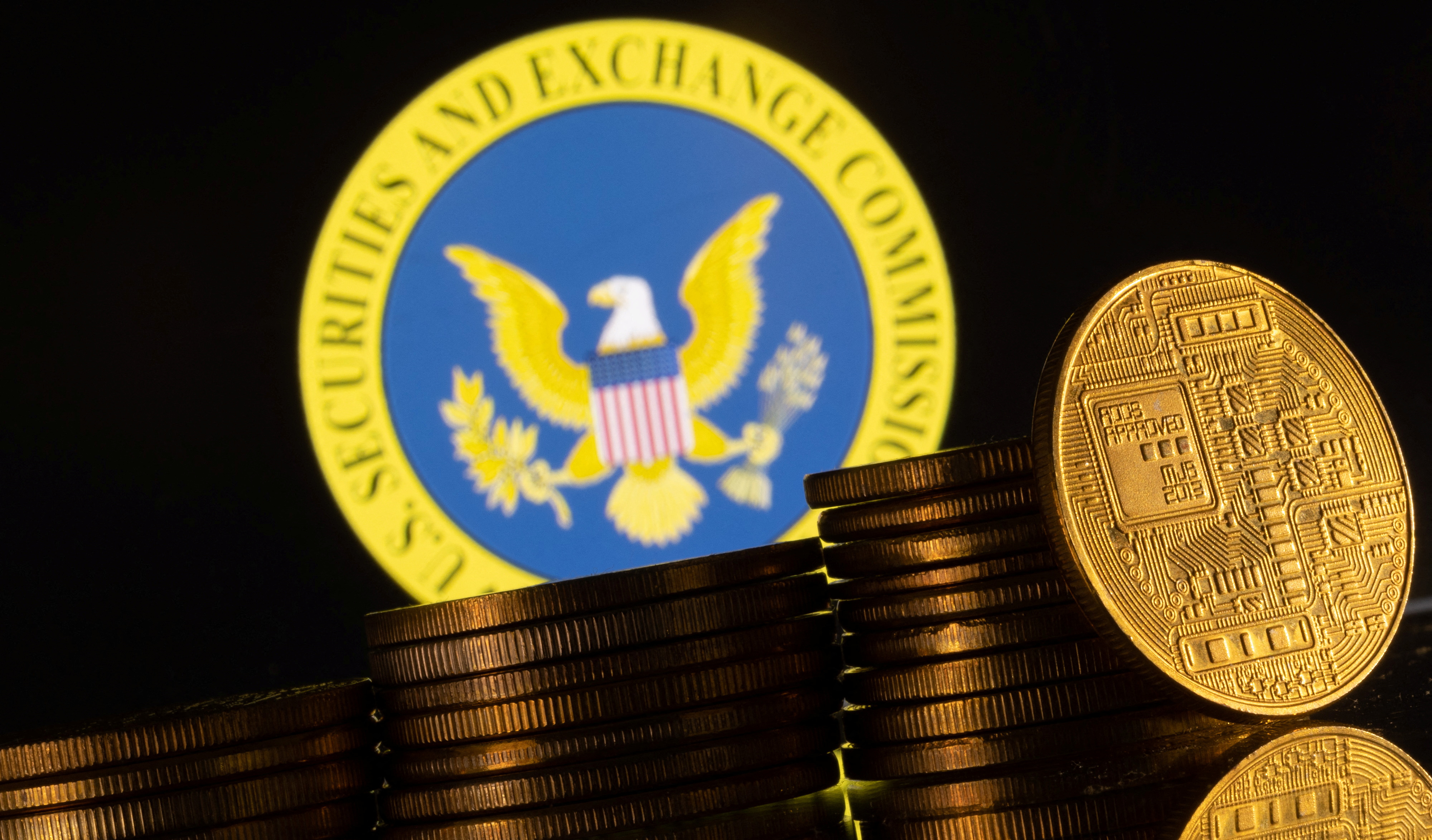 Illustration shows U.S. Securities and Exchange Commission logo and representations of cryptocurrency