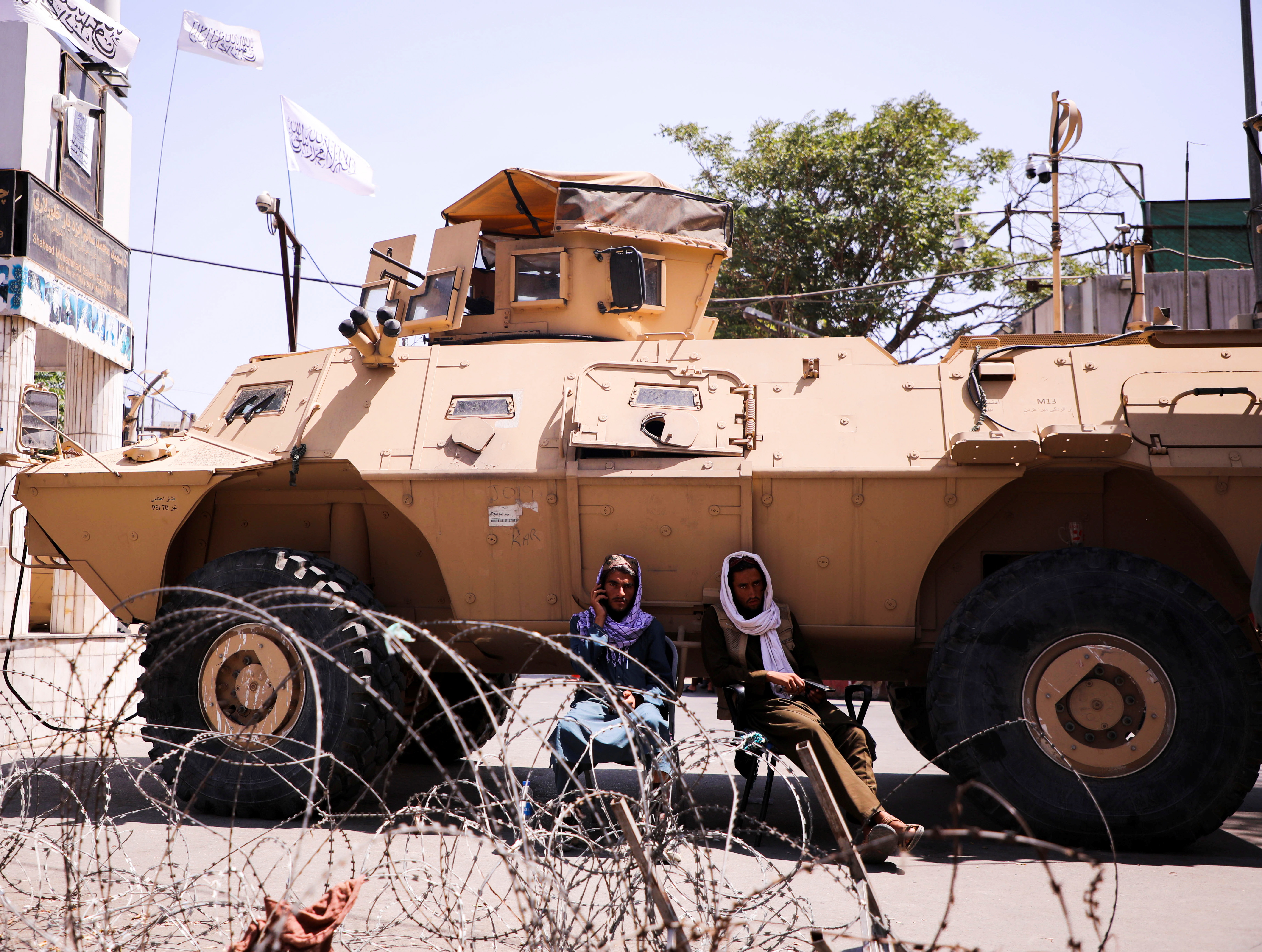 Taliban forces with their armoured vehicles block the road near the presidential place in Kabul