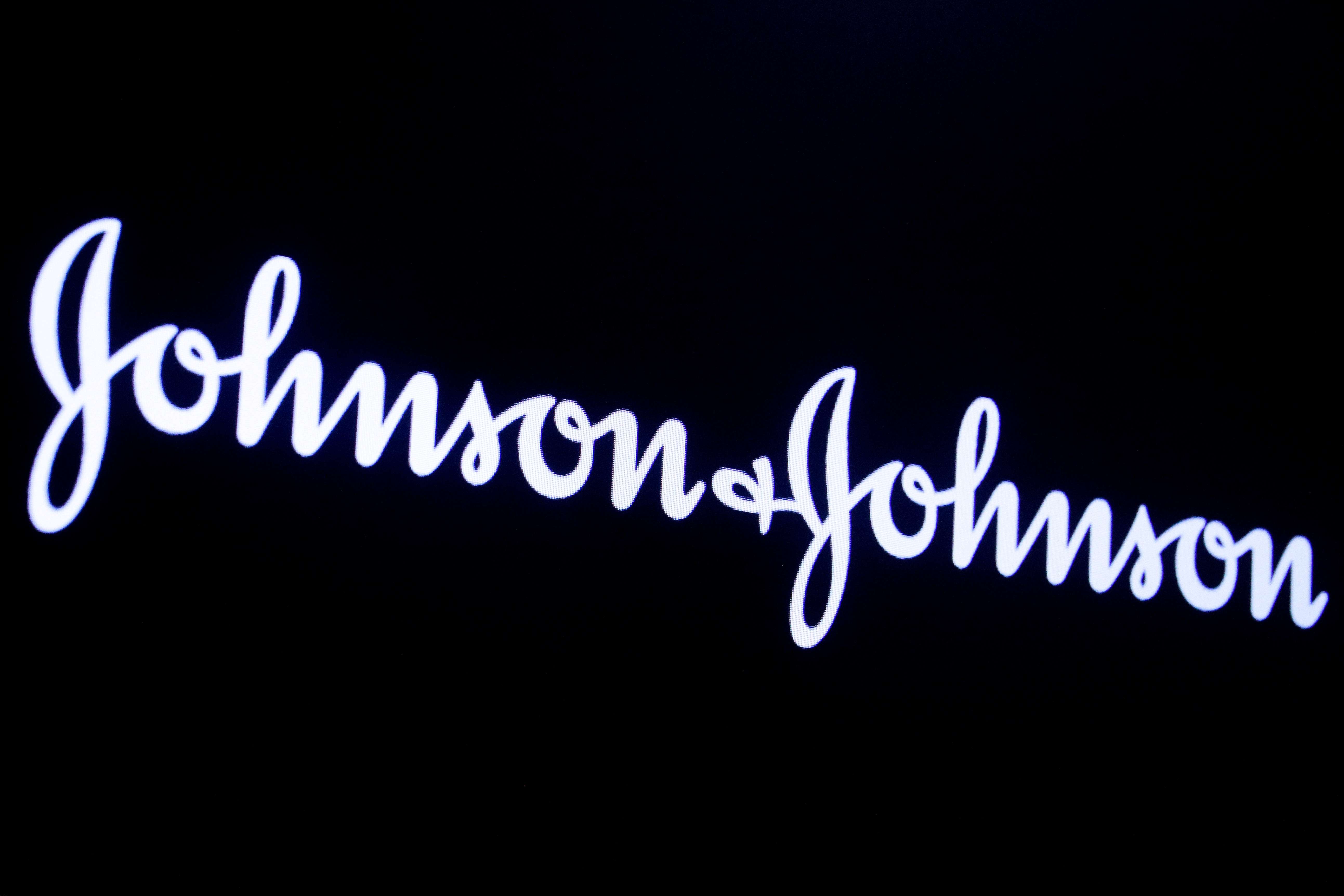 The company logo for Johnson & Johnson is displayed on a screen to celebrate the 75th anniversary of the company's listing at the NYSE in New York