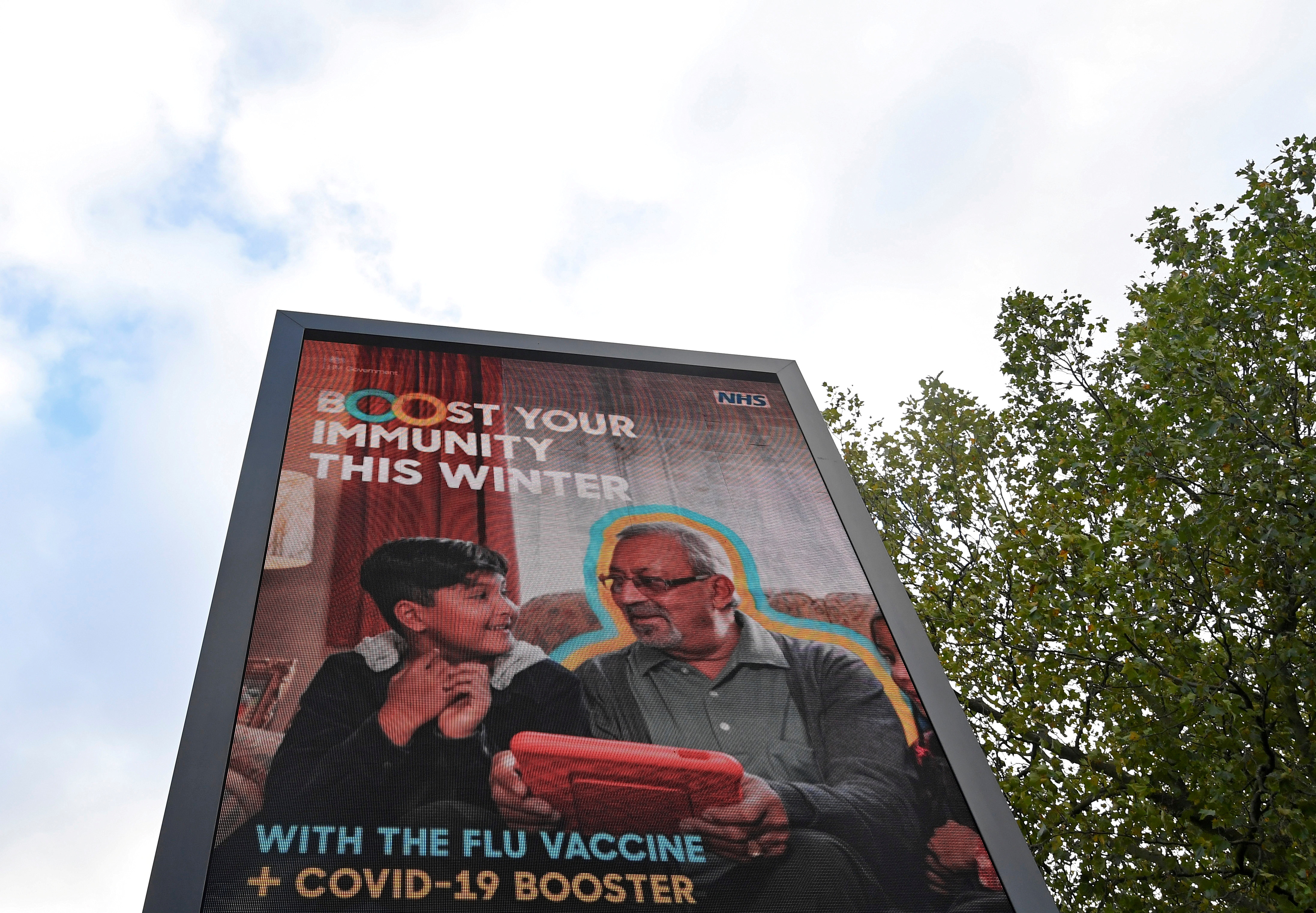 An NHS COVID-19 vaccination health campaign advertisement is displayed, amidst the spread of the coronavirus disease (COVID-19), in London, Britain, October 21, 2021. REUTERS/Toby Melville/File Photo