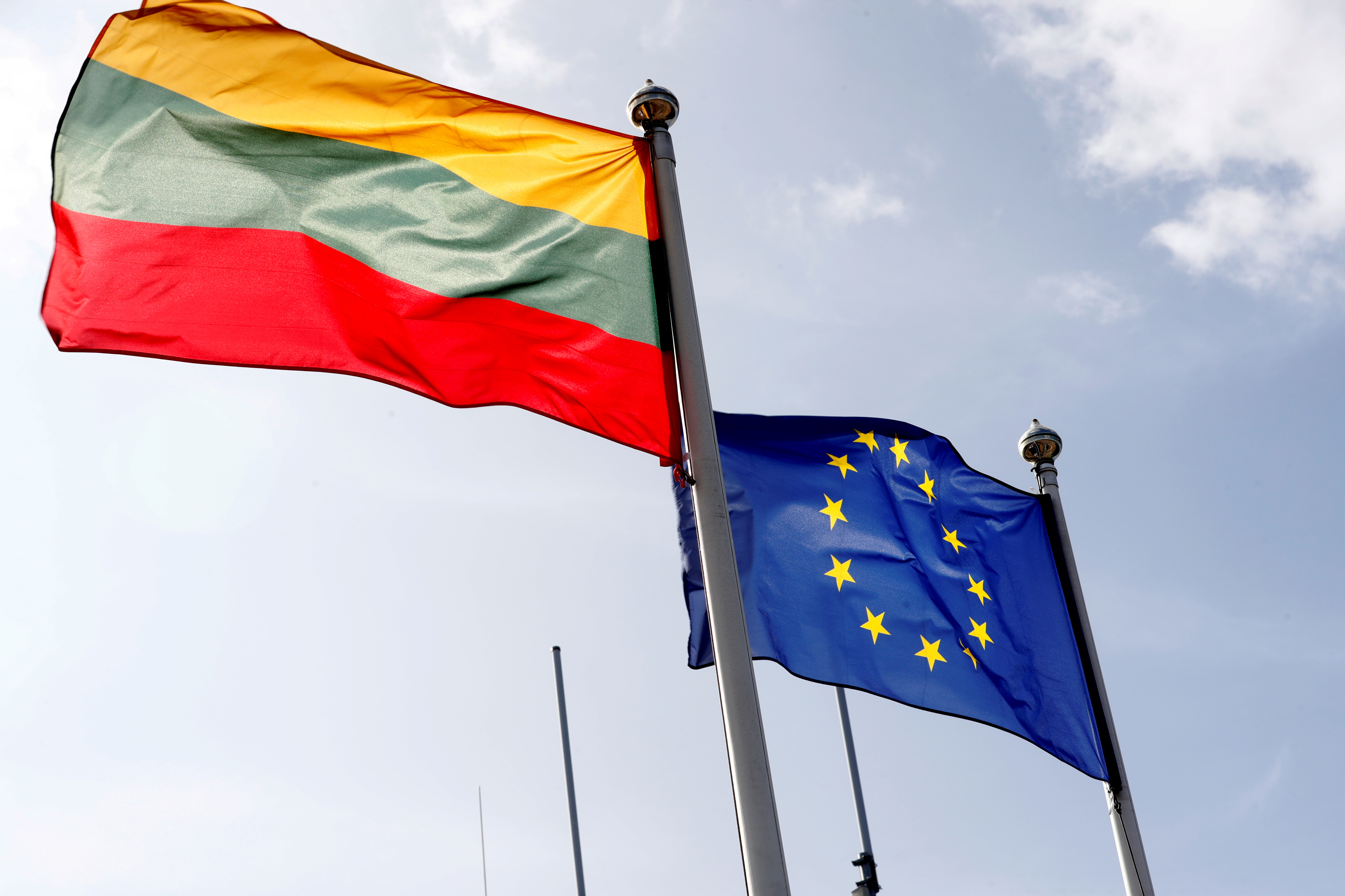 European Union and Lithuanian flags flutter at border crossing point in Medininkai