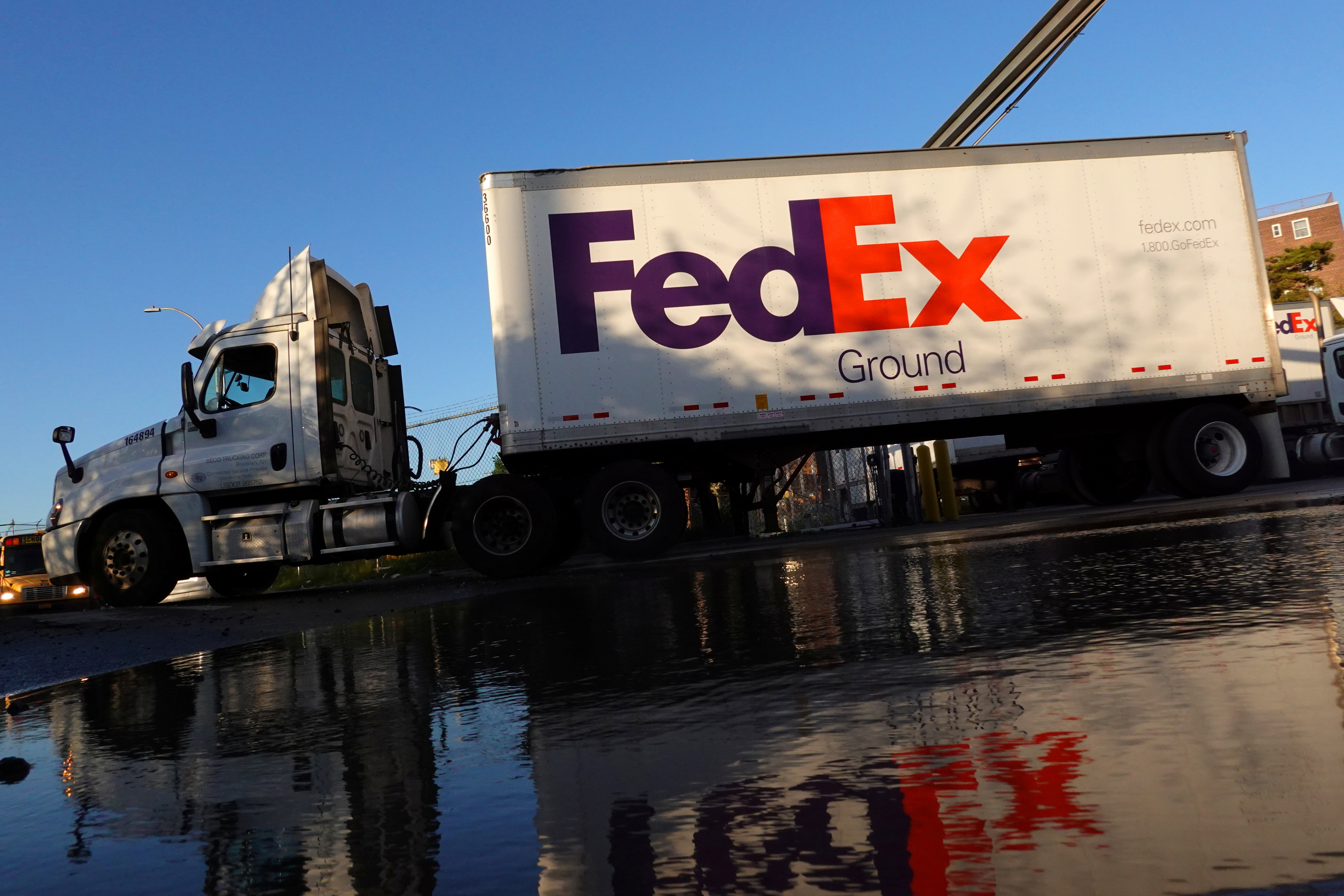 A FedEx delivery truck exits a facility in Brooklyn, New York City