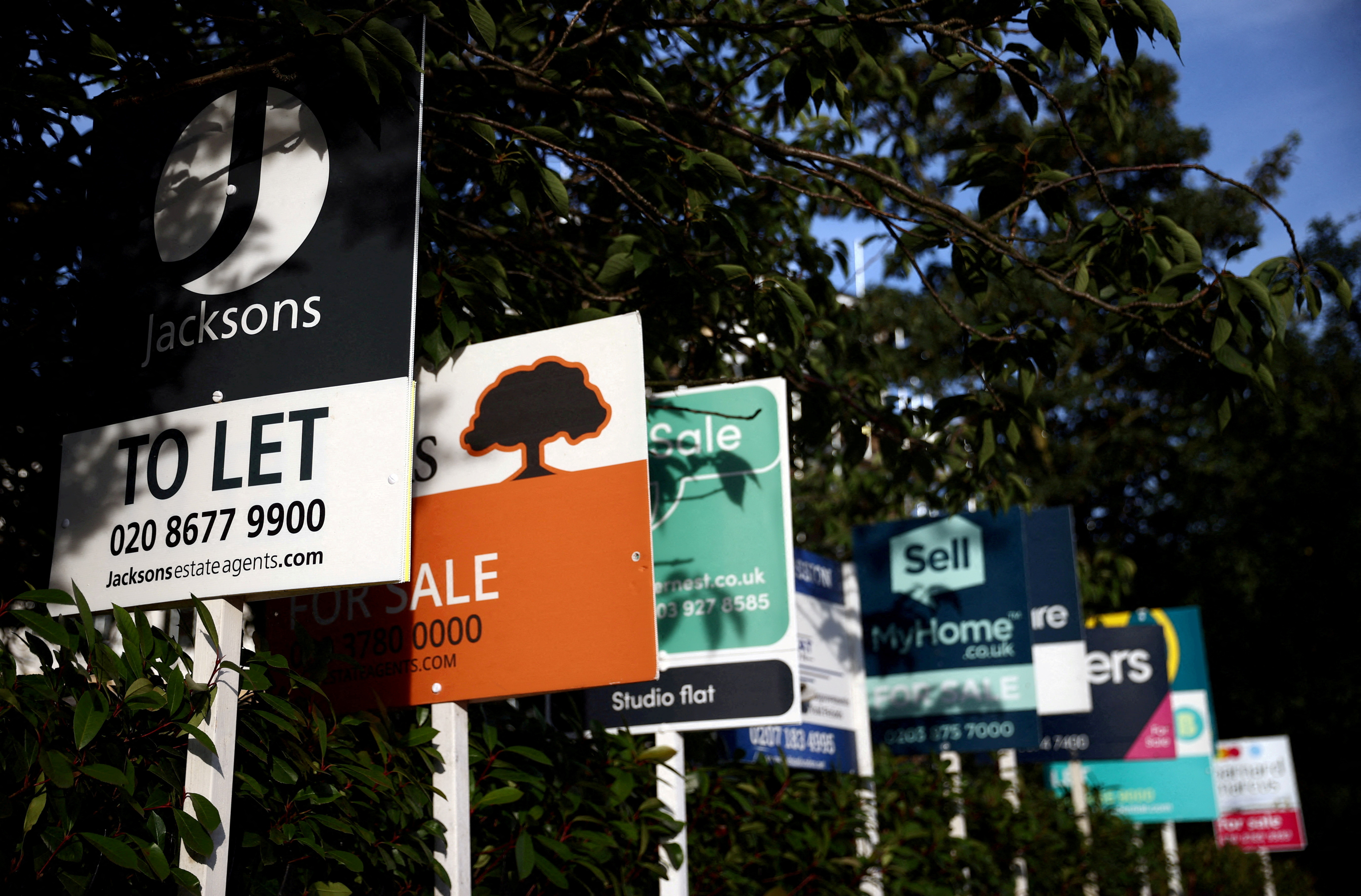 Estate agent signs are seen in south London