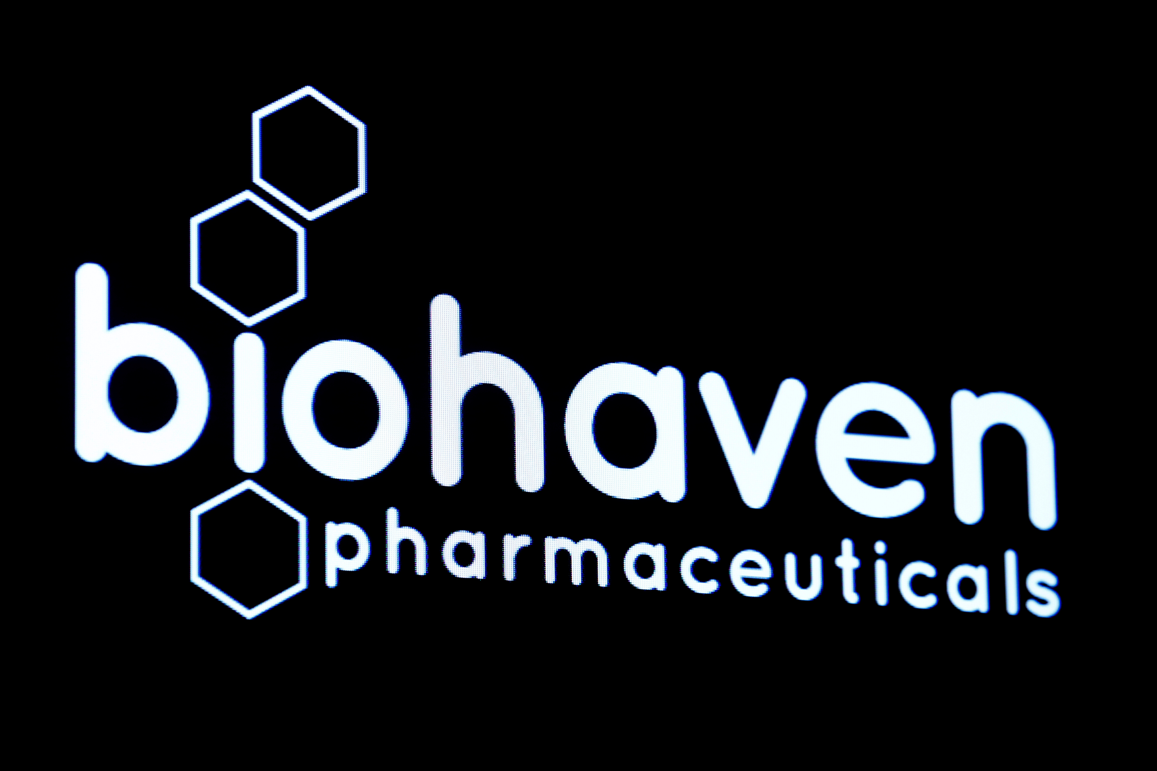 Biohaven Pharmaceutical Holding Company logo is displayed on screen on floor of NYSE in New York