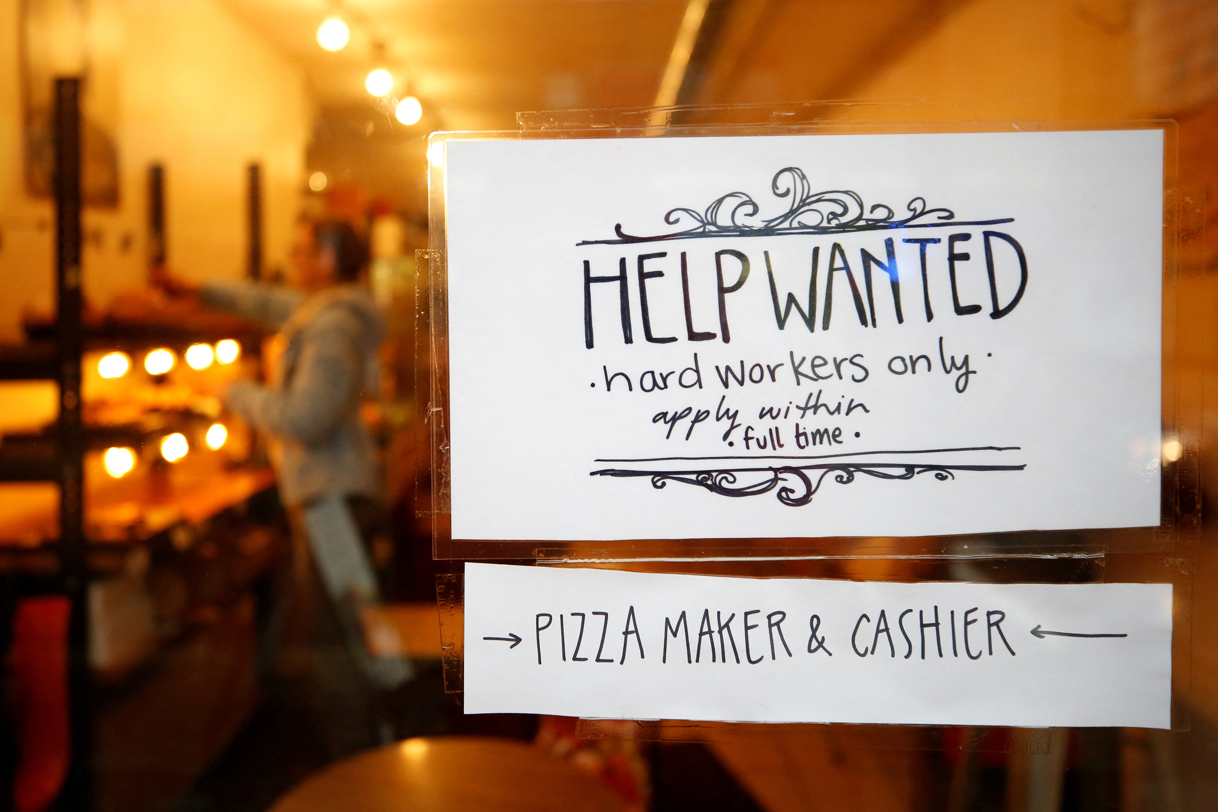 A "Help wanted" sign in the window of a bakery in Ottawa Canada