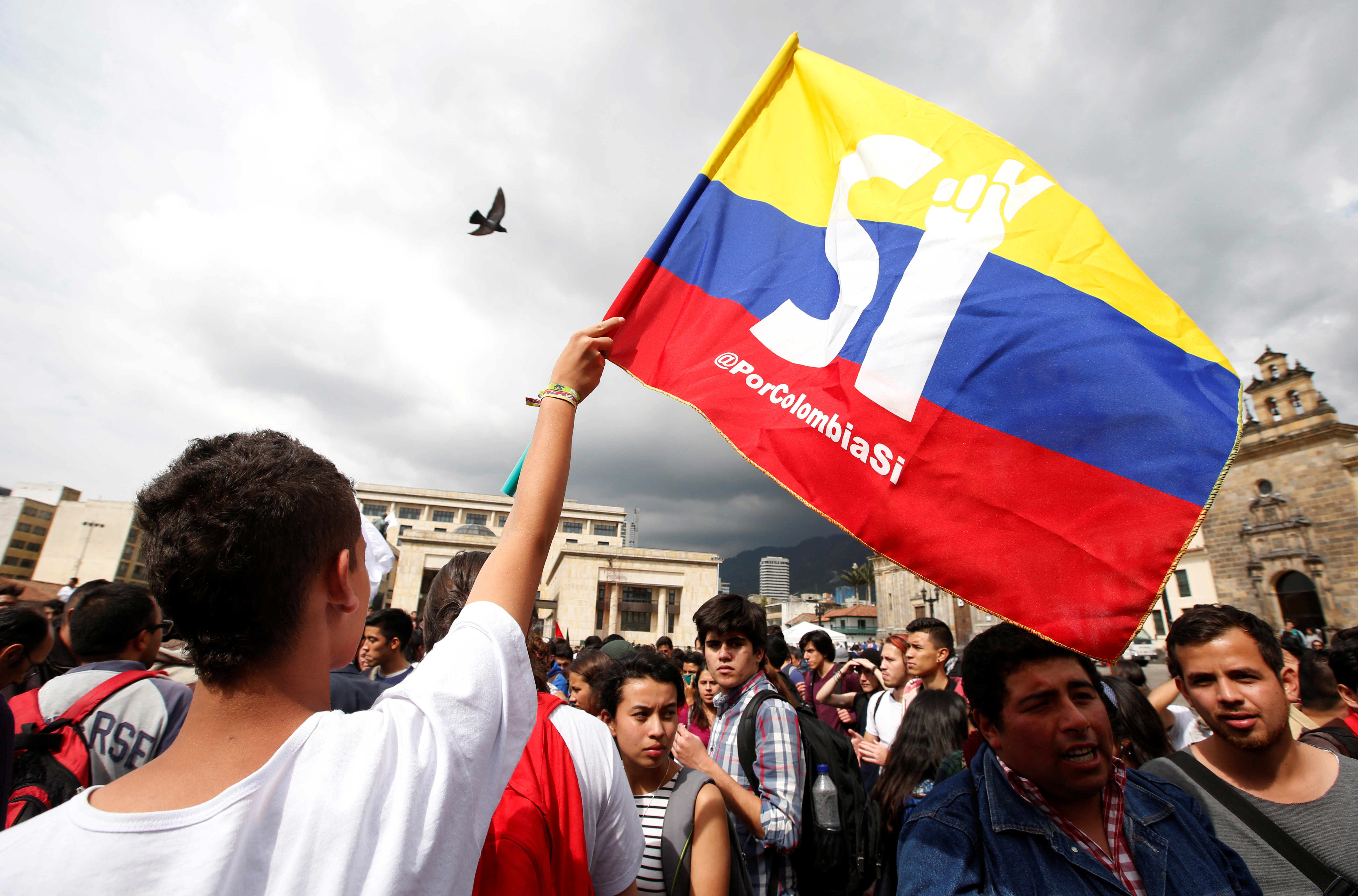 University students and supporters of the peace deal signed between the government and Revolutionary Armed Forces of Colombia (FARC) rebels display a flag during a rally in front of Congress in Bogota