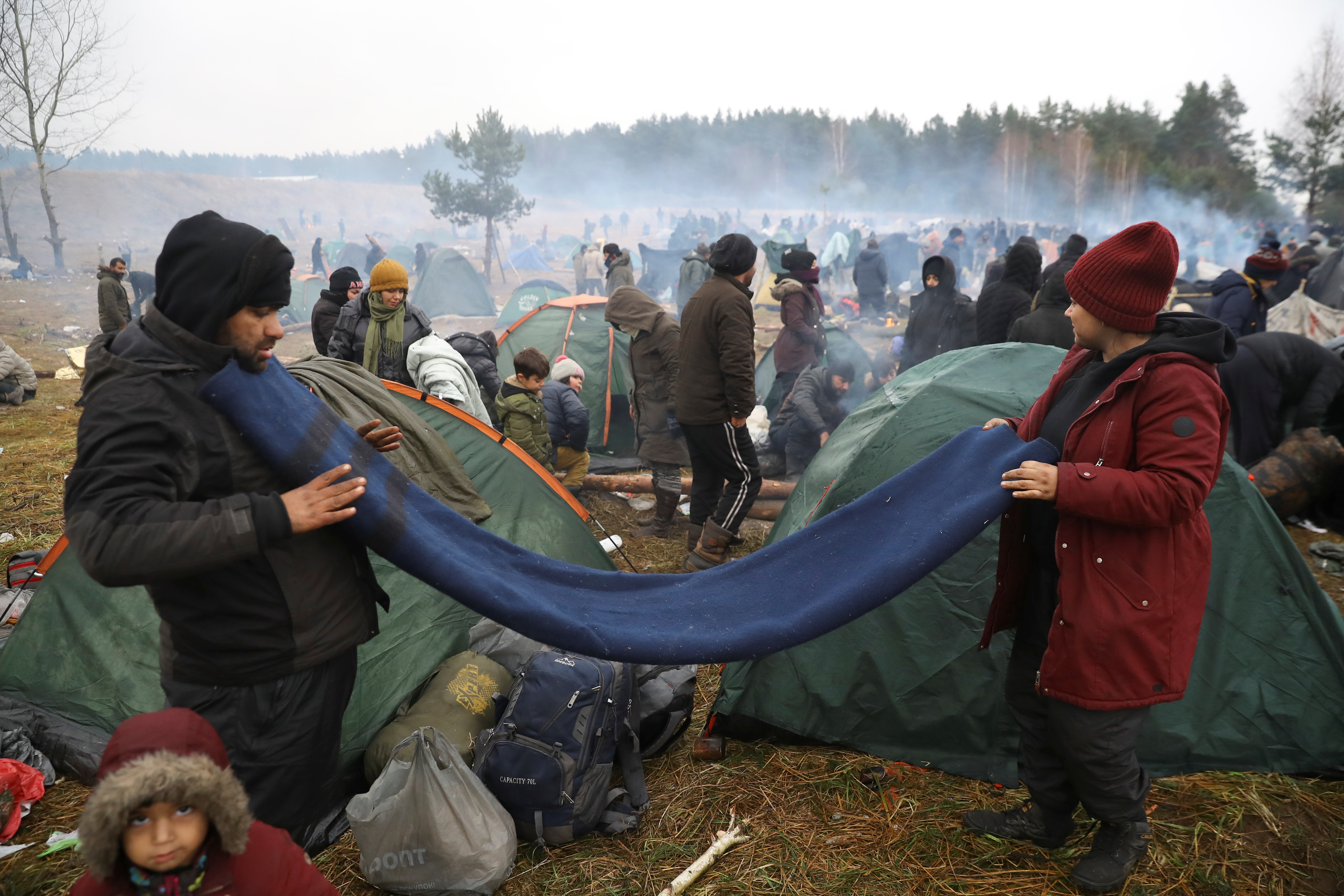 Migrants gather in a camp near Bruzgi-Kuznica checkpoint on the Belarusian-Polish border in the Grodno region, Belarus, November 18, 2021.  REUTERS/Kacper Pempel