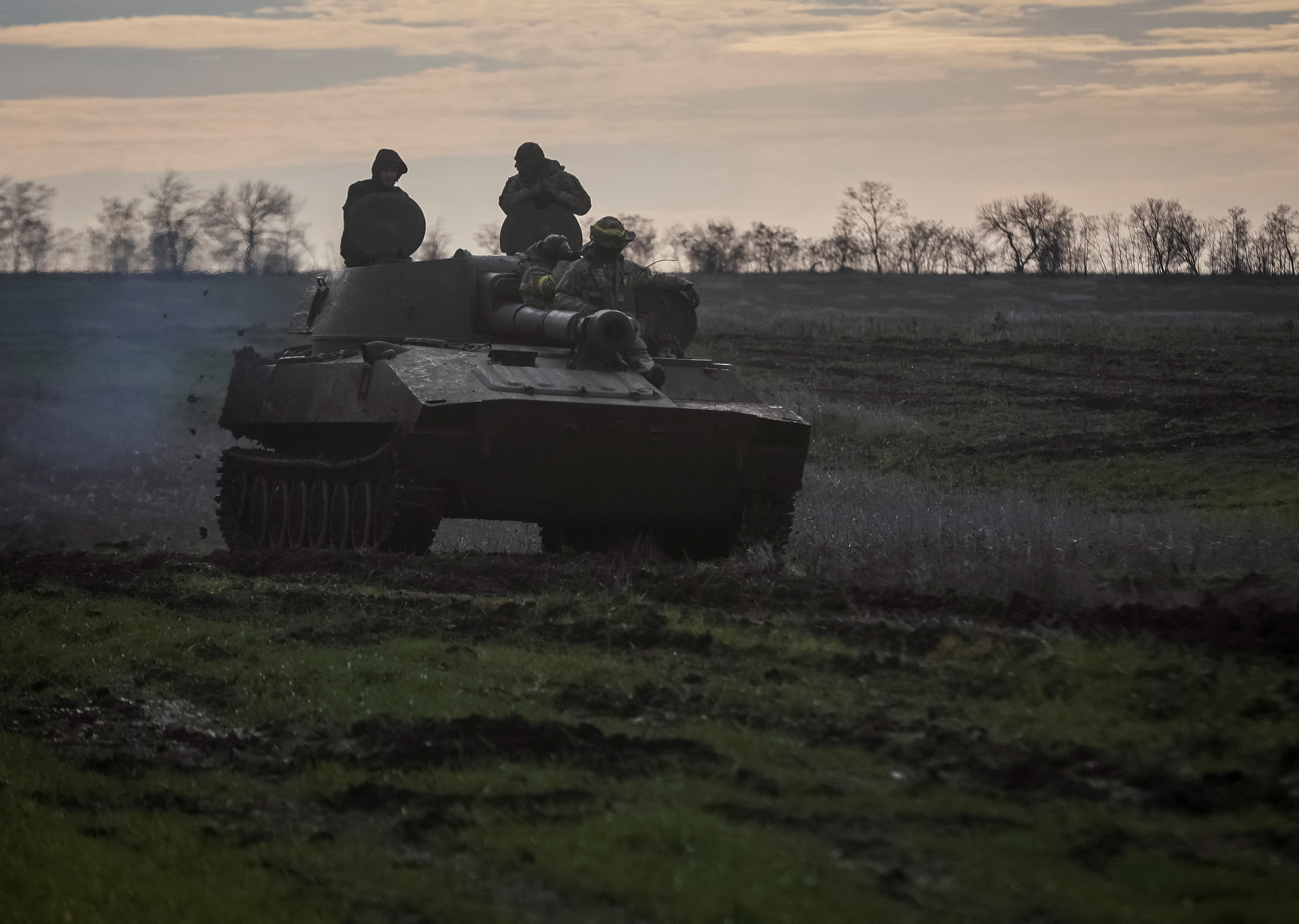 Ukrainian servicemen ride a self-propelled howitzer on a frontline in Donetsk region