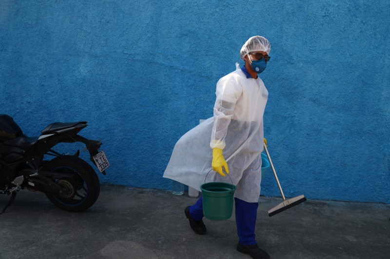 A cleaning worker prepares to disinfect an Emergency Mobile Care Service (SAMU) ambulance after taking a suspected COVID-19 patient, amid the coronavirus disease (COVID-19) outbreak, in the Moacyr do Carmo hospital in Duque de Caxias near Rio de Janeiro, Brazil May 20, 2021. REUTERS/Pilar Olivares