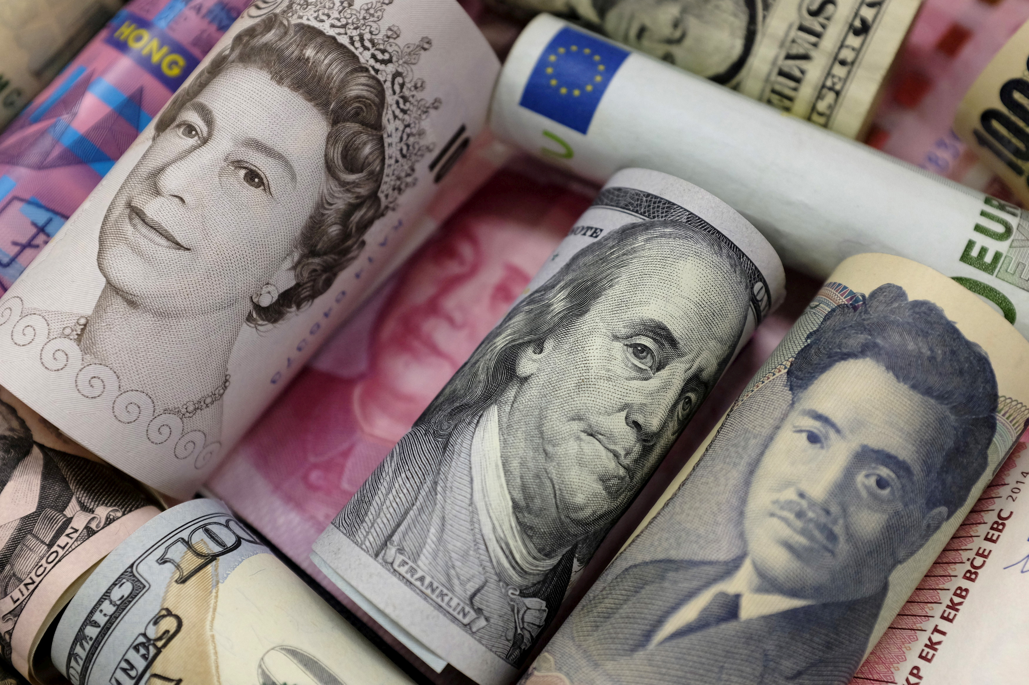 Banknotes of Euro, Hong Kong dollar, U.S. dollar, Japanese yen, GB pound and Chinese 100 yuan are seen in this picture illustration, in Beijing