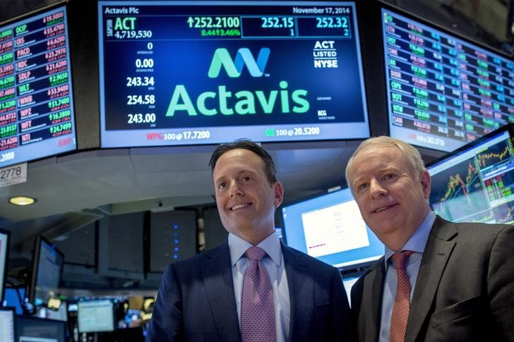 Actavis CEO Brenton Saunders and Allergan CEO David Pyotton pose together on the floor of the New York Stock Exchange