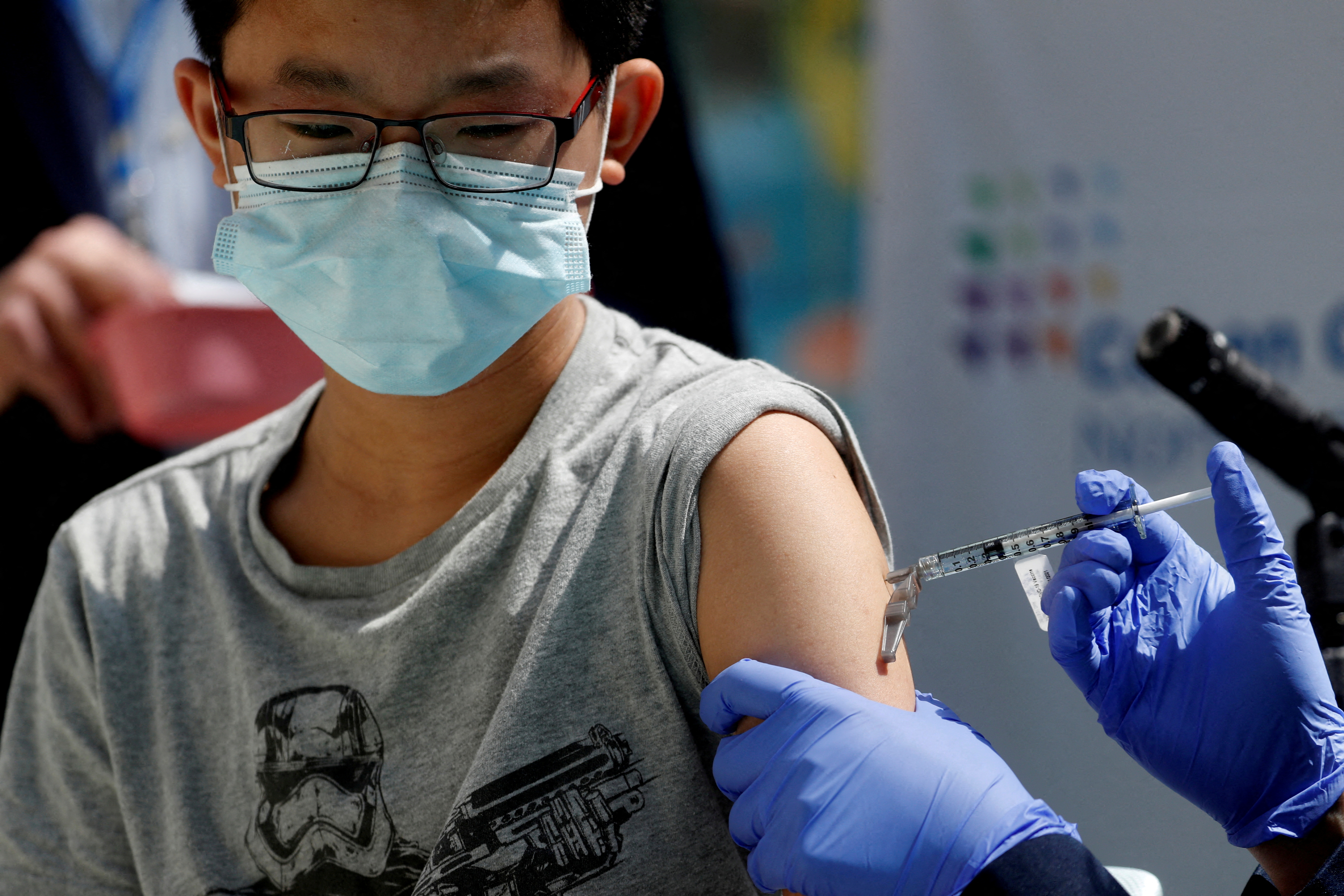 FILE PHOTO: Children receive Pfizer-BioNTech vaccine for the coronavirus disease (COVID-19) in New Hyde Park, New York