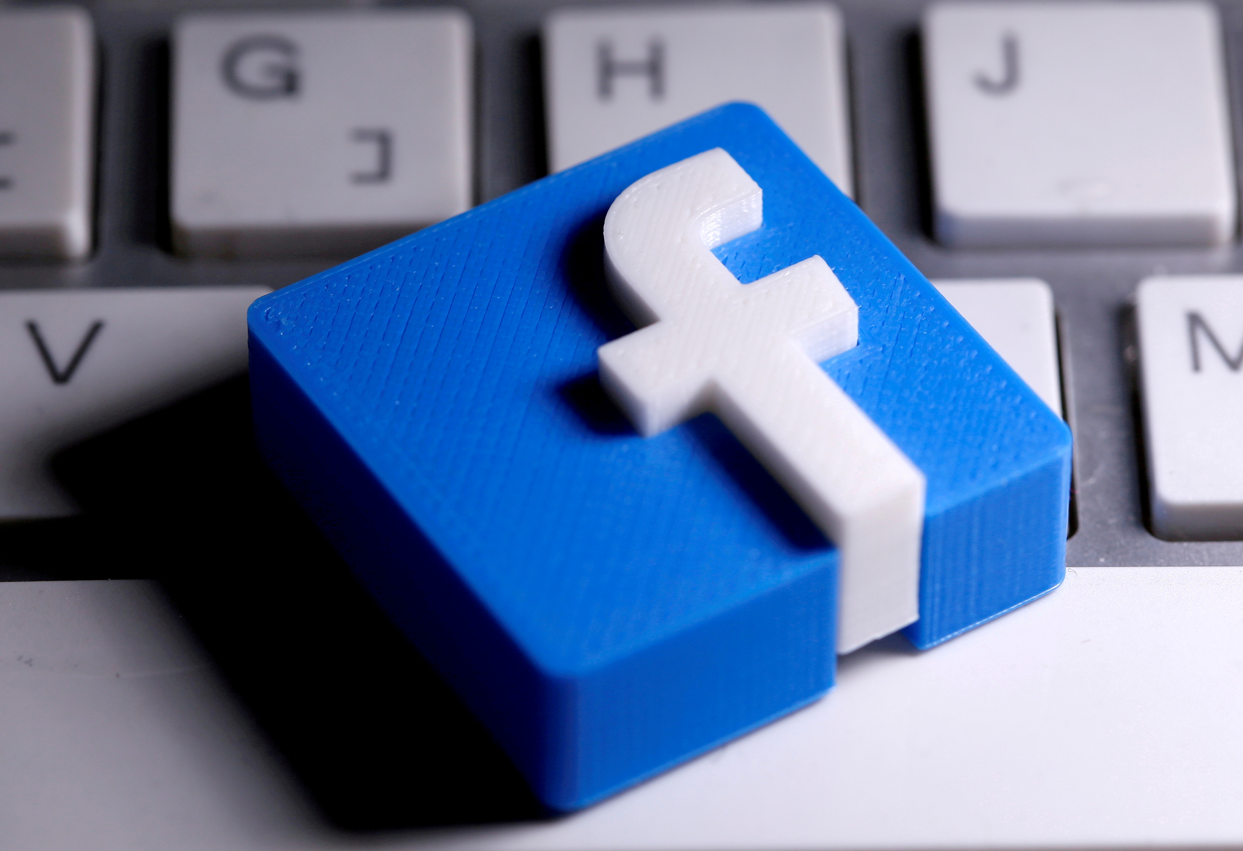 3D-printed Facebook logo is seen placed on a keyboard in this illustration taken March 25, 2020. REUTERS/Dado Ruvic/Illustration