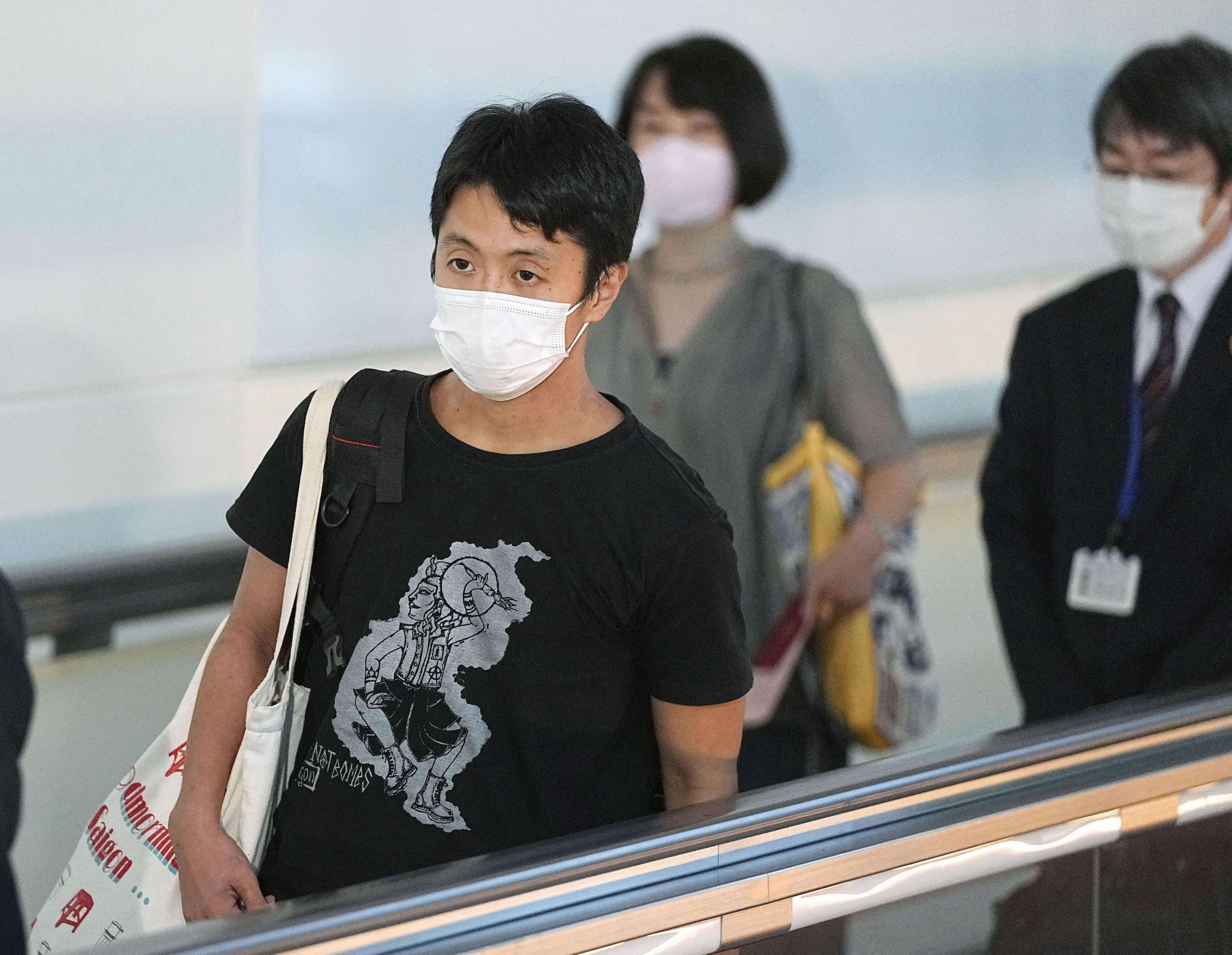 Toru Kubota, a Japanese filmmaker held by authorities in Myanmar and who has been freed, arrives at Haneda Airport, in Tokyo