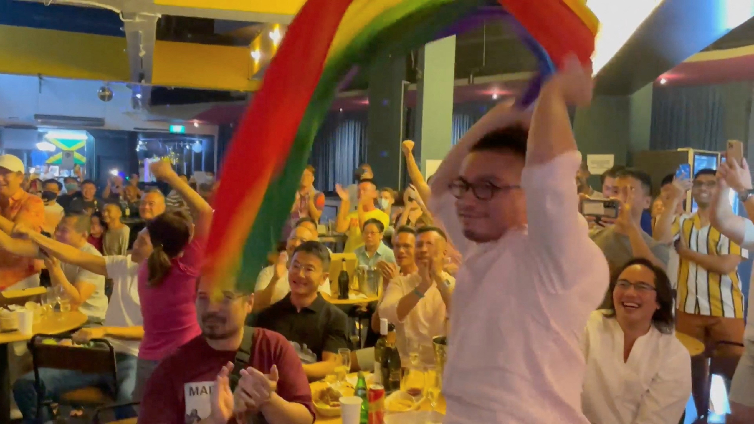 People react as Singapore's Prime Minister Lee Hsien Loong announces that Singapore will decriminalise gay sex