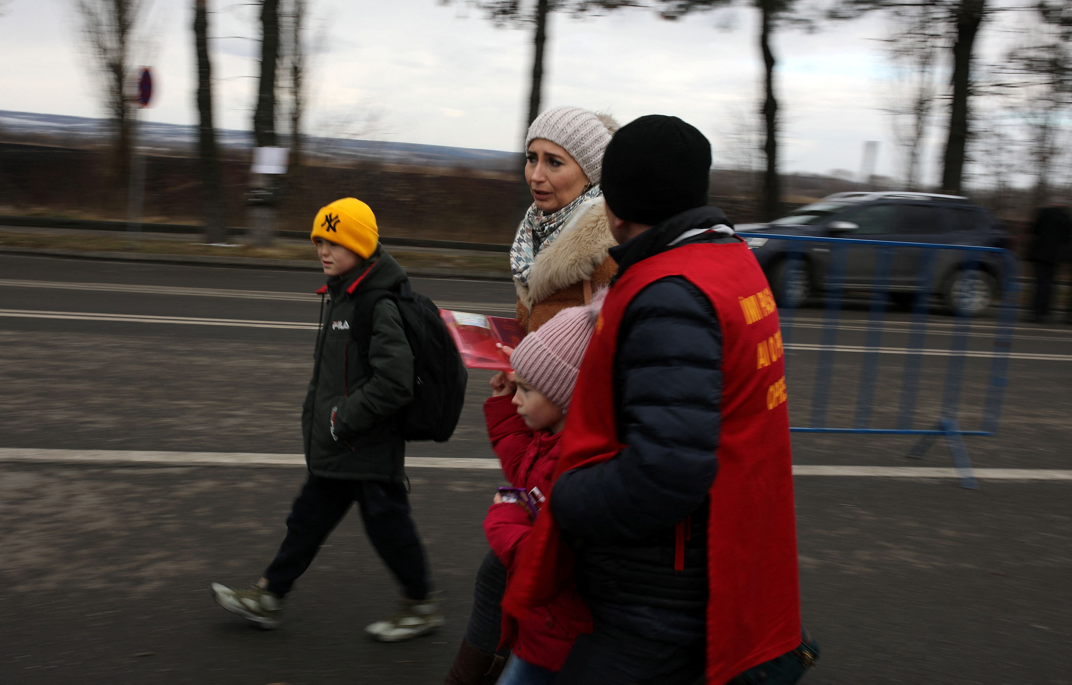 People flee from Ukraine to Romania at the border crossing in Siret