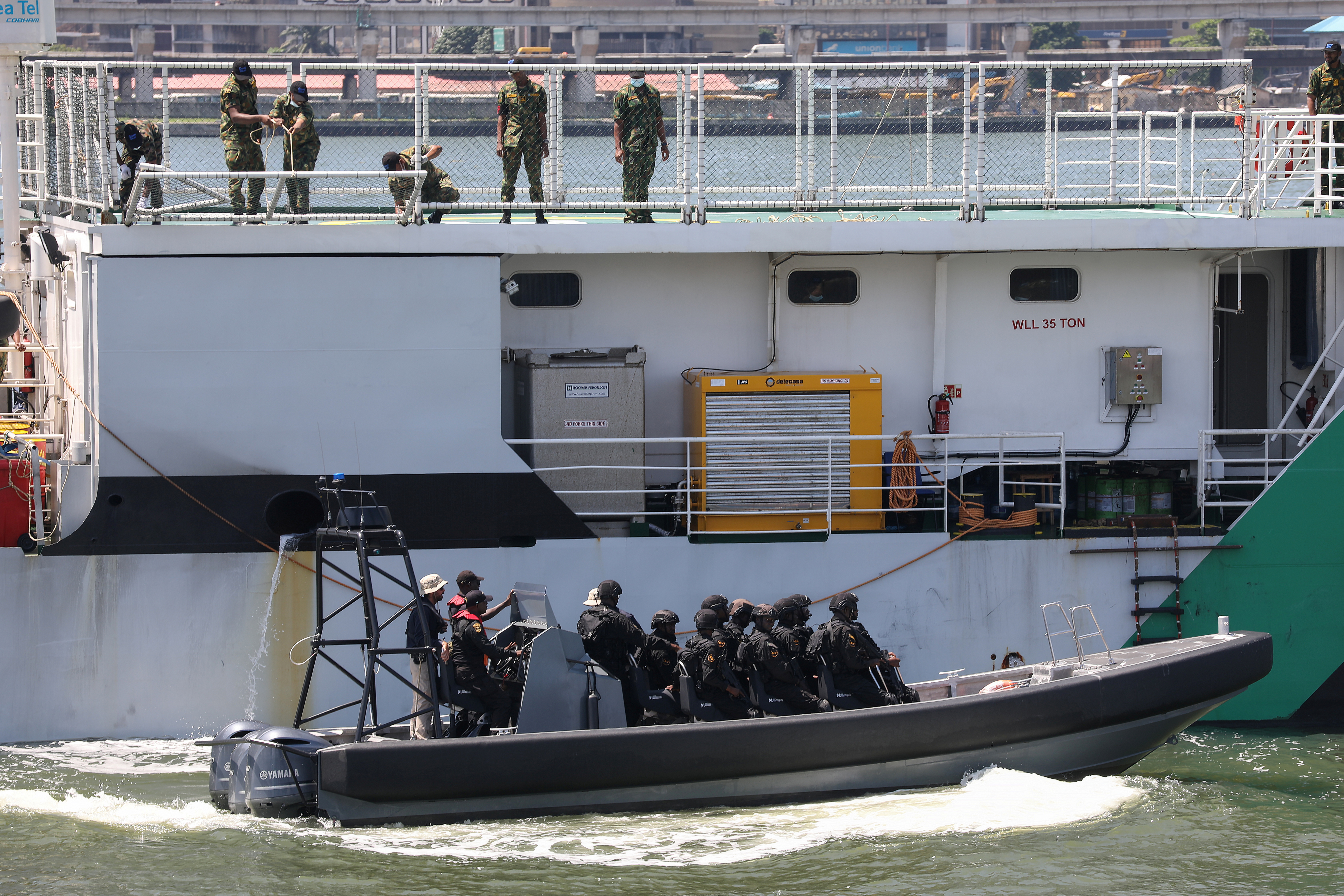 Members of the Maritime Security Unit prepare to board a vessel as they stage an anti-piracy drill during the launch of the Deep Blue project by the Nigerian government in Apapa, Lagos,