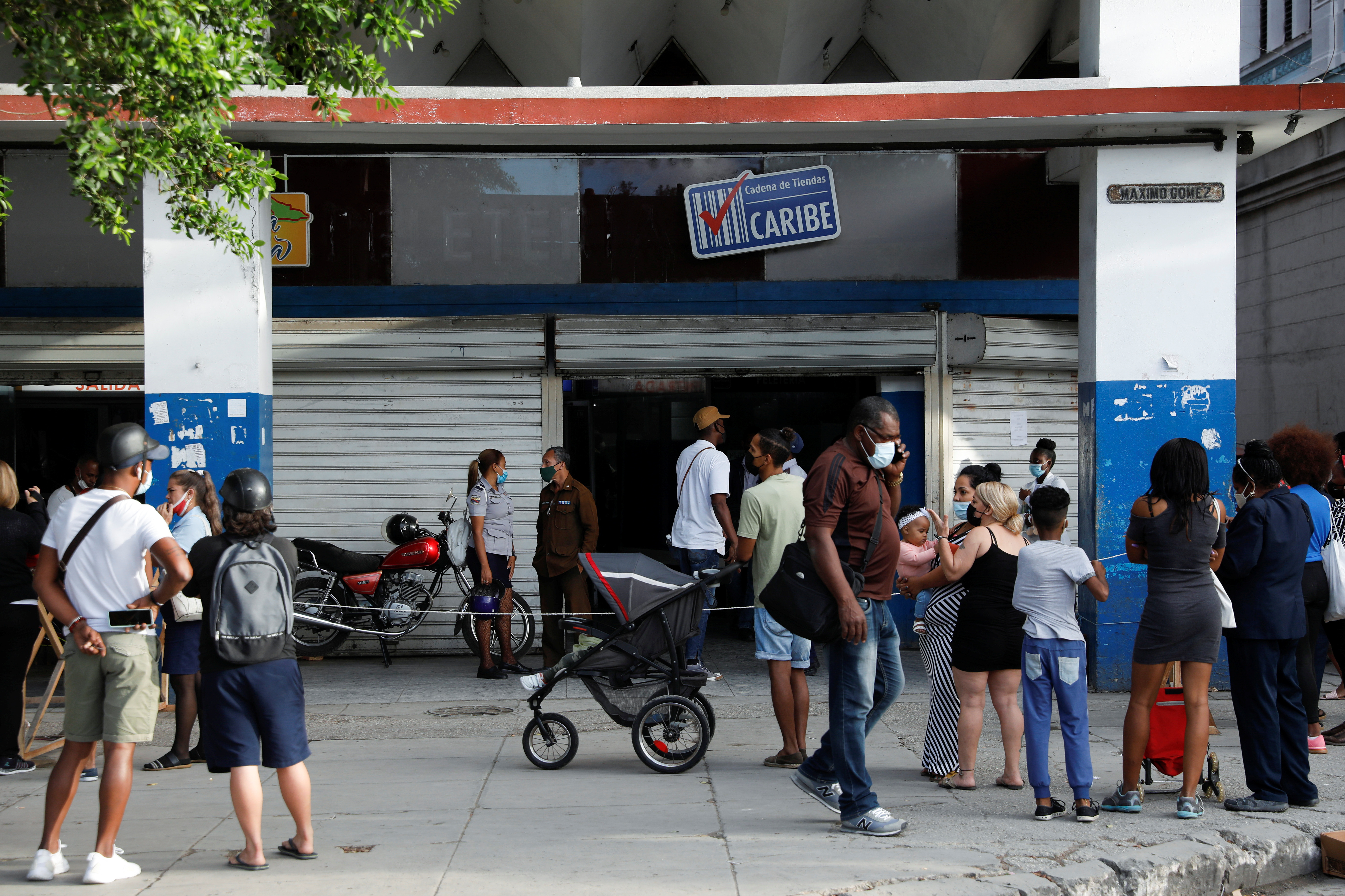 People line up to enter a store in downtown Havana