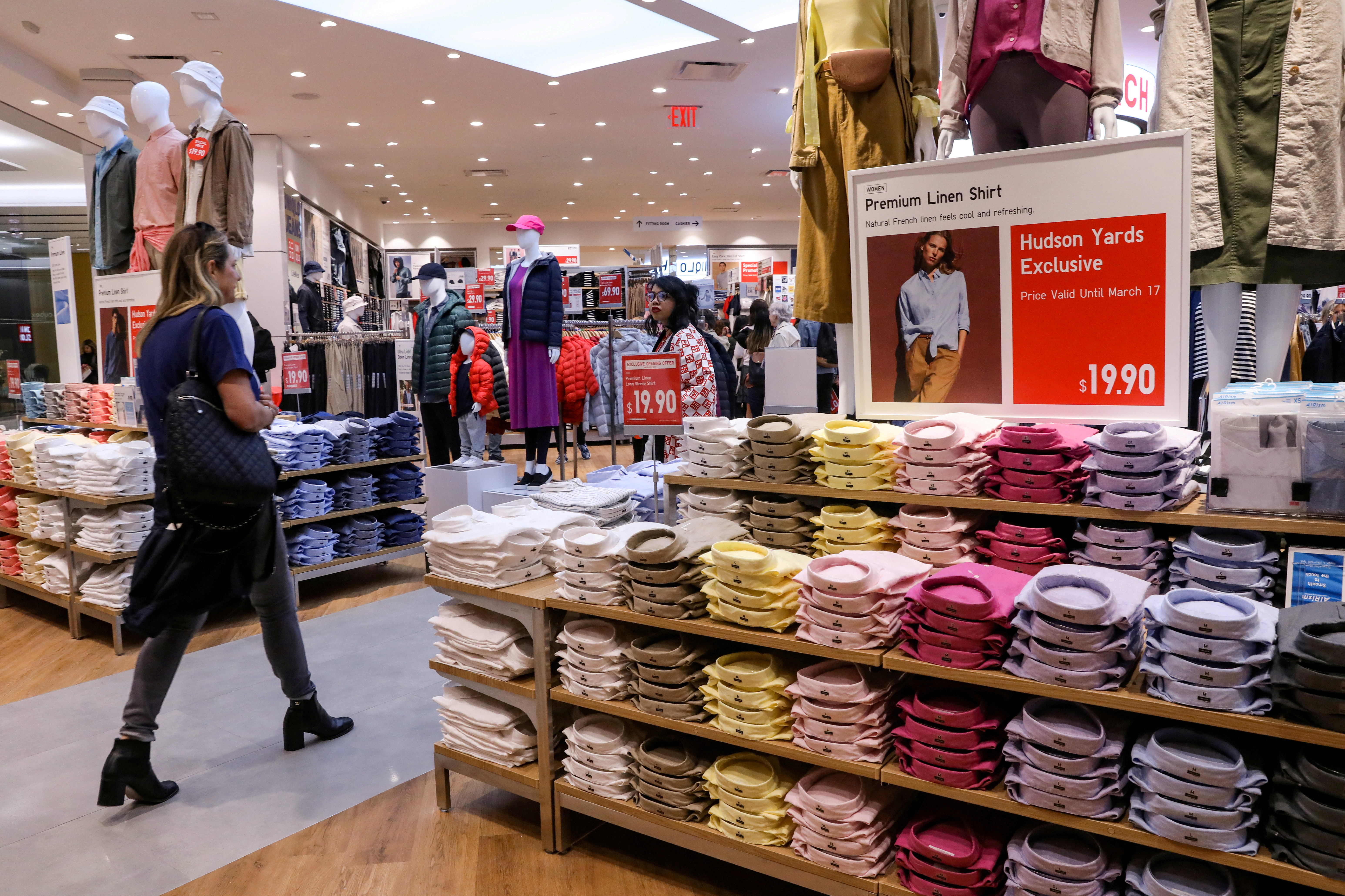 People shop at a UNIQLO store during the grand opening of the The Hudson Yards development in New York