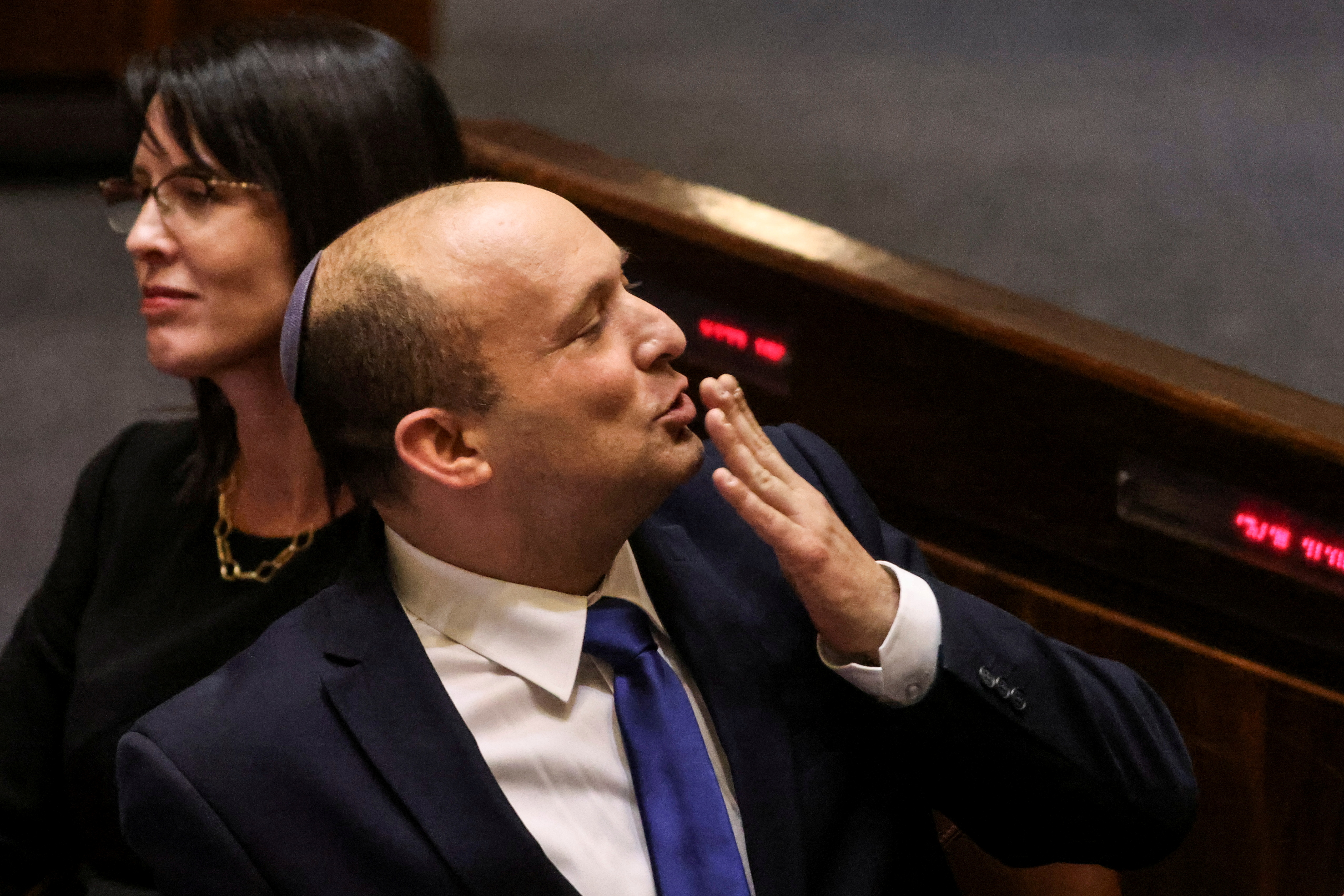 Naftali Bennett, Prime Minister-designate, gestures at the Knesset, Israel's parliament, during a special session whereby a confidence vote will be held to approve and swear-in a new coalition government, in Jerusalem