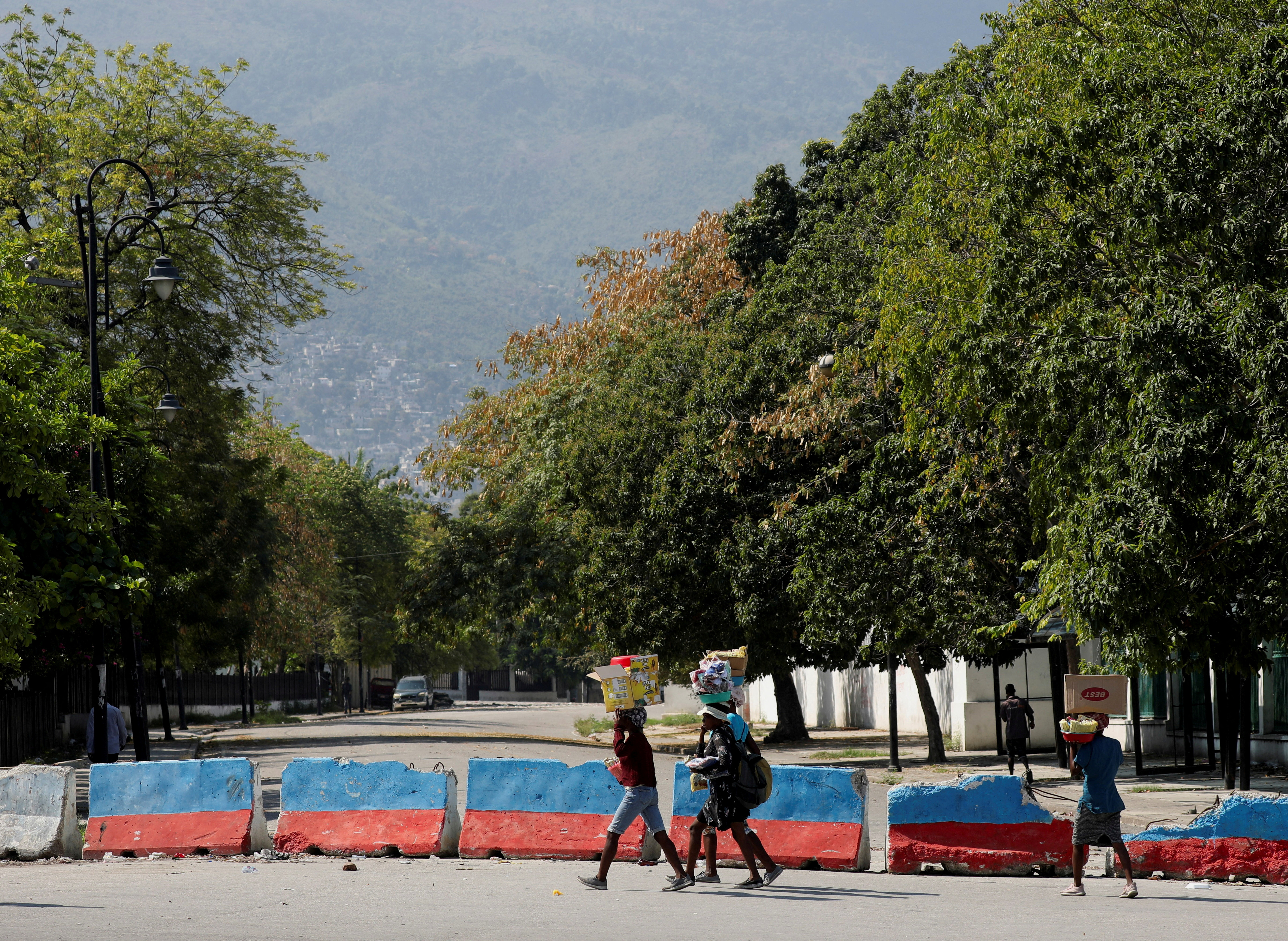 After prime minister pledges to step down, uneasy quiet in Haiti capital
