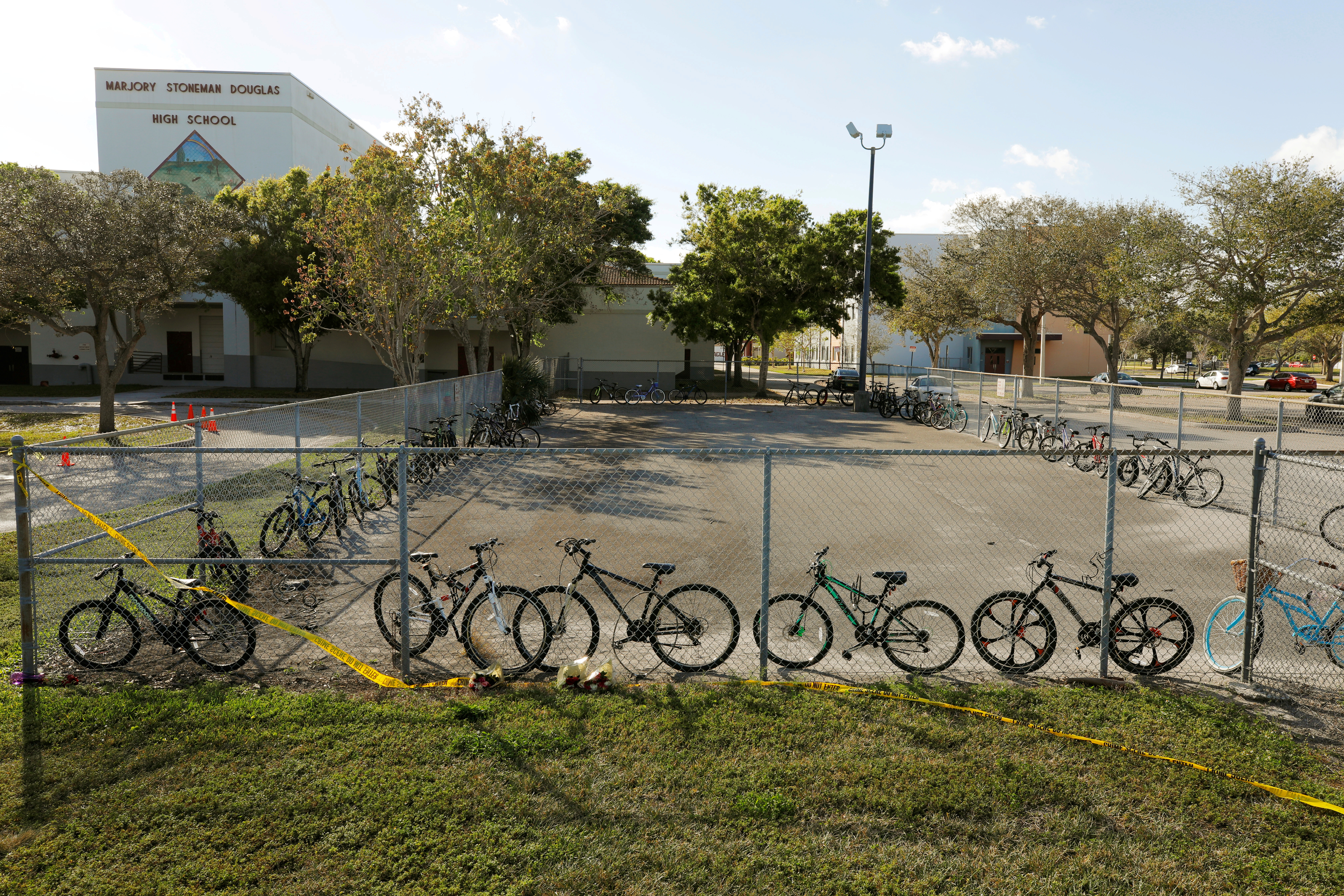 Bicycles used to go to school on the day of the shooting at Marjory Stoneman Douglas High School remain on campus four days after the event in Parkland, Florida, U.S. February 18, 2018.   REUTERS/Jonathan Drake/File Photo