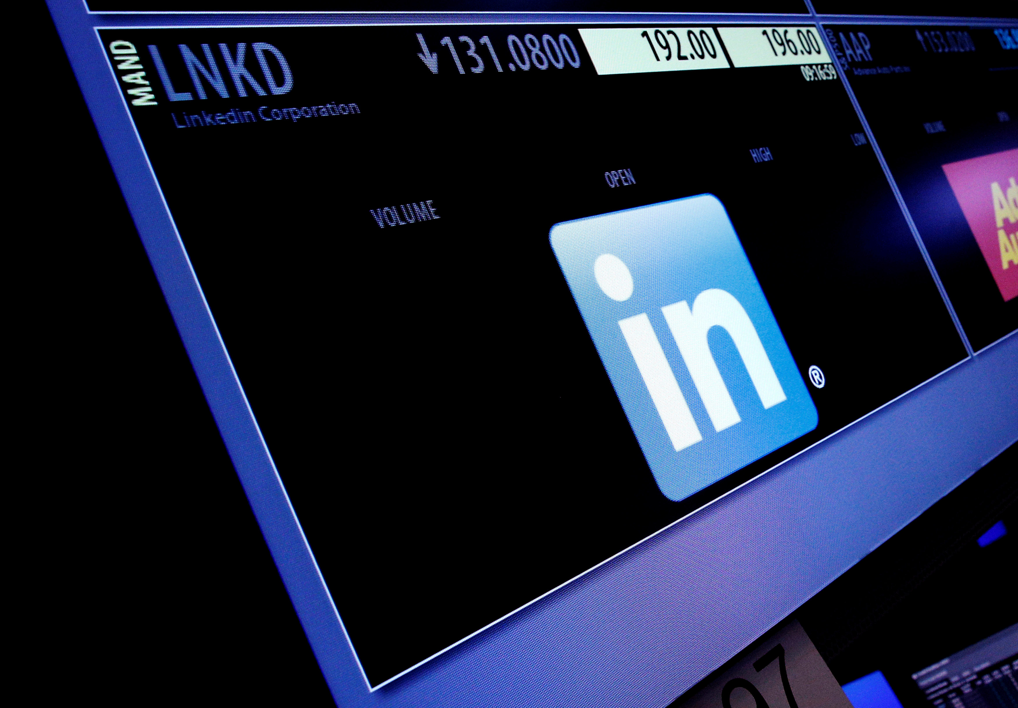 The ticker symbol and trading information for LinkedIn Corp. is displayed on a screen  at the post where it is traded, before the start of trading, on the floor of the New York Stock Exchange (NYSE) in New York City, U.S., June 13, 2016. REUTERS/Brendan McDermid