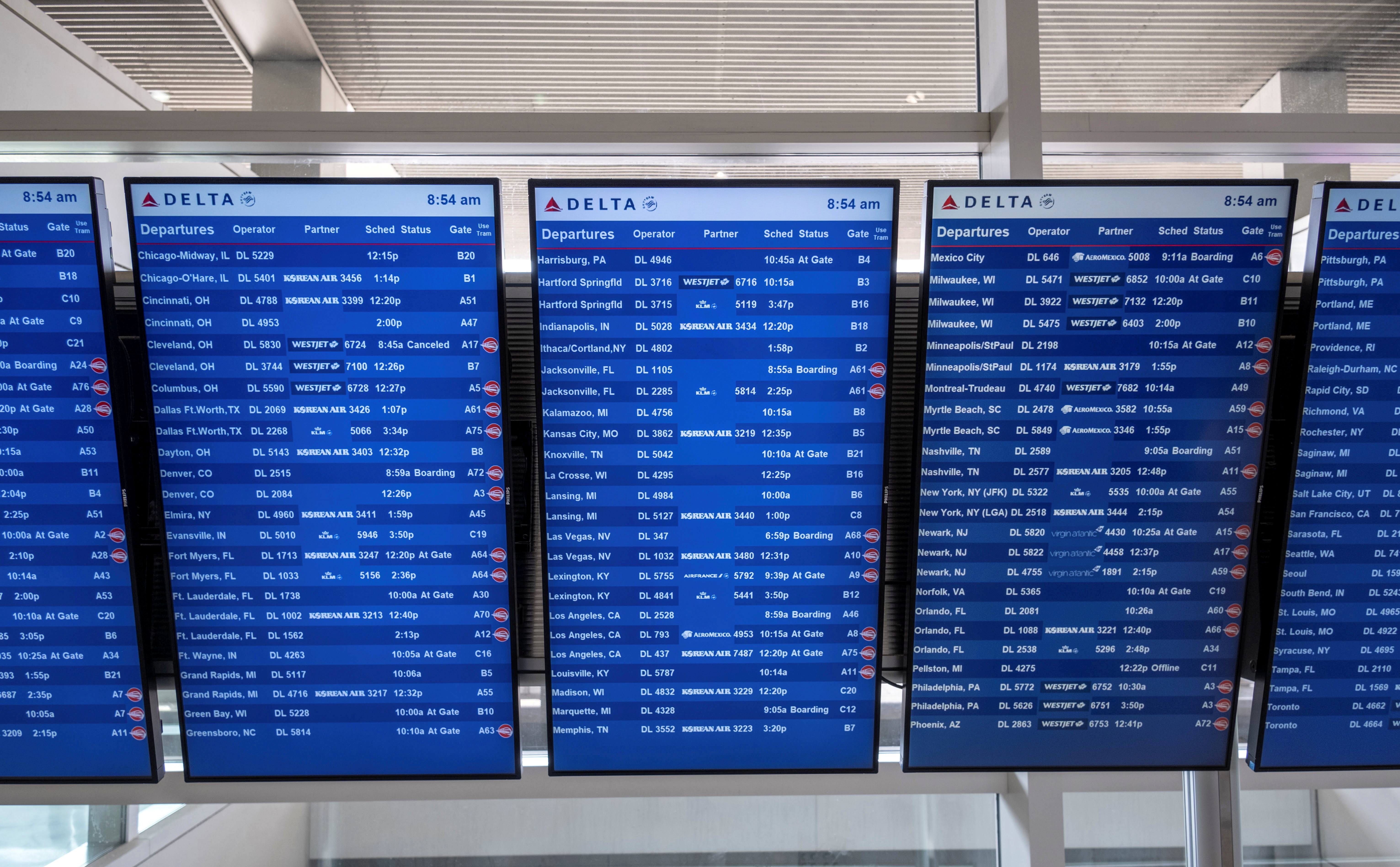 Flight information display screens are seen at the Detroit Metropolitan Wayne County Airport in Detroit