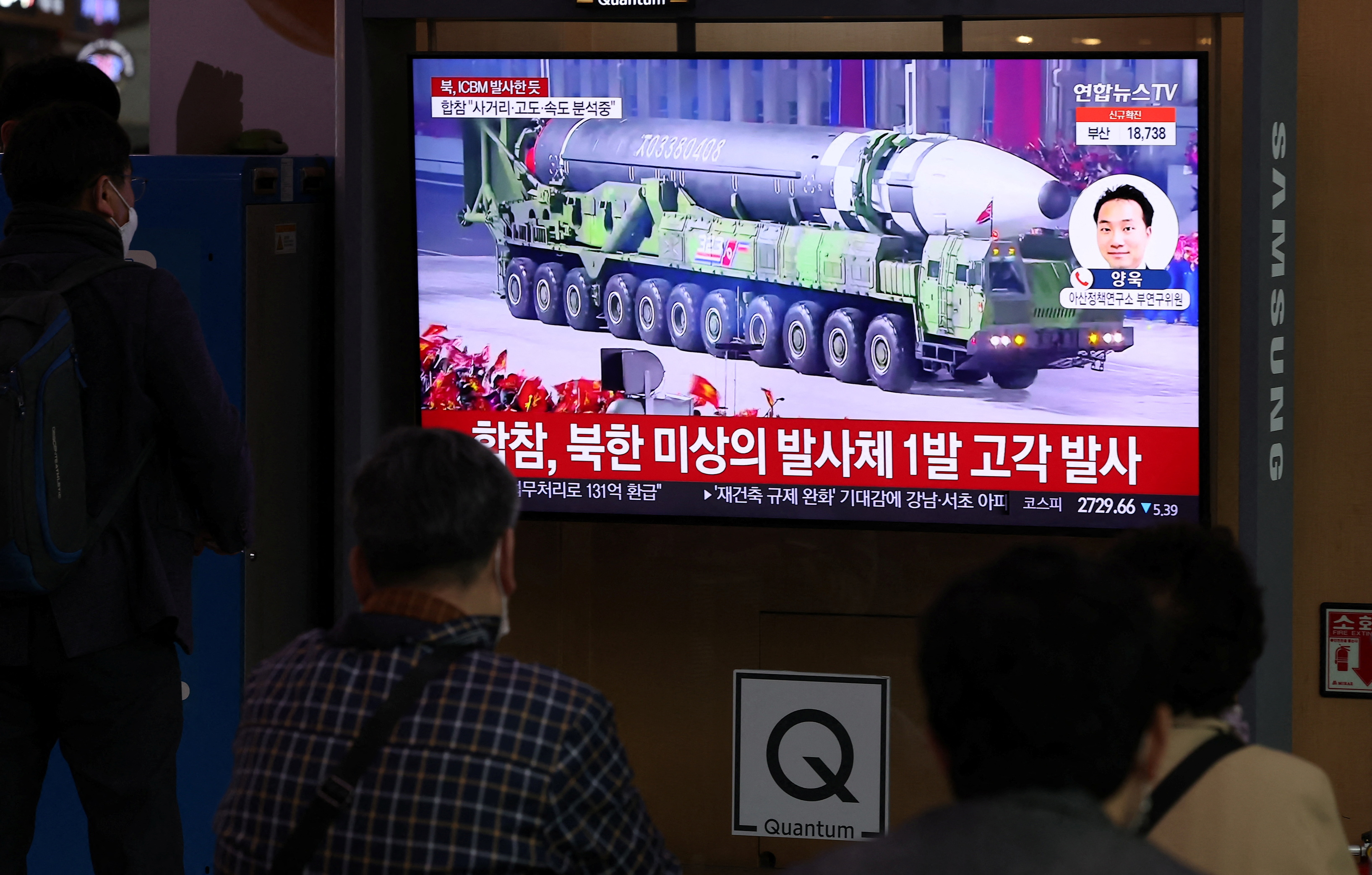 People watch a TV broadcasting a news report on North Korea's intercontinental ballistic missile (ICBM) test, in Seoul