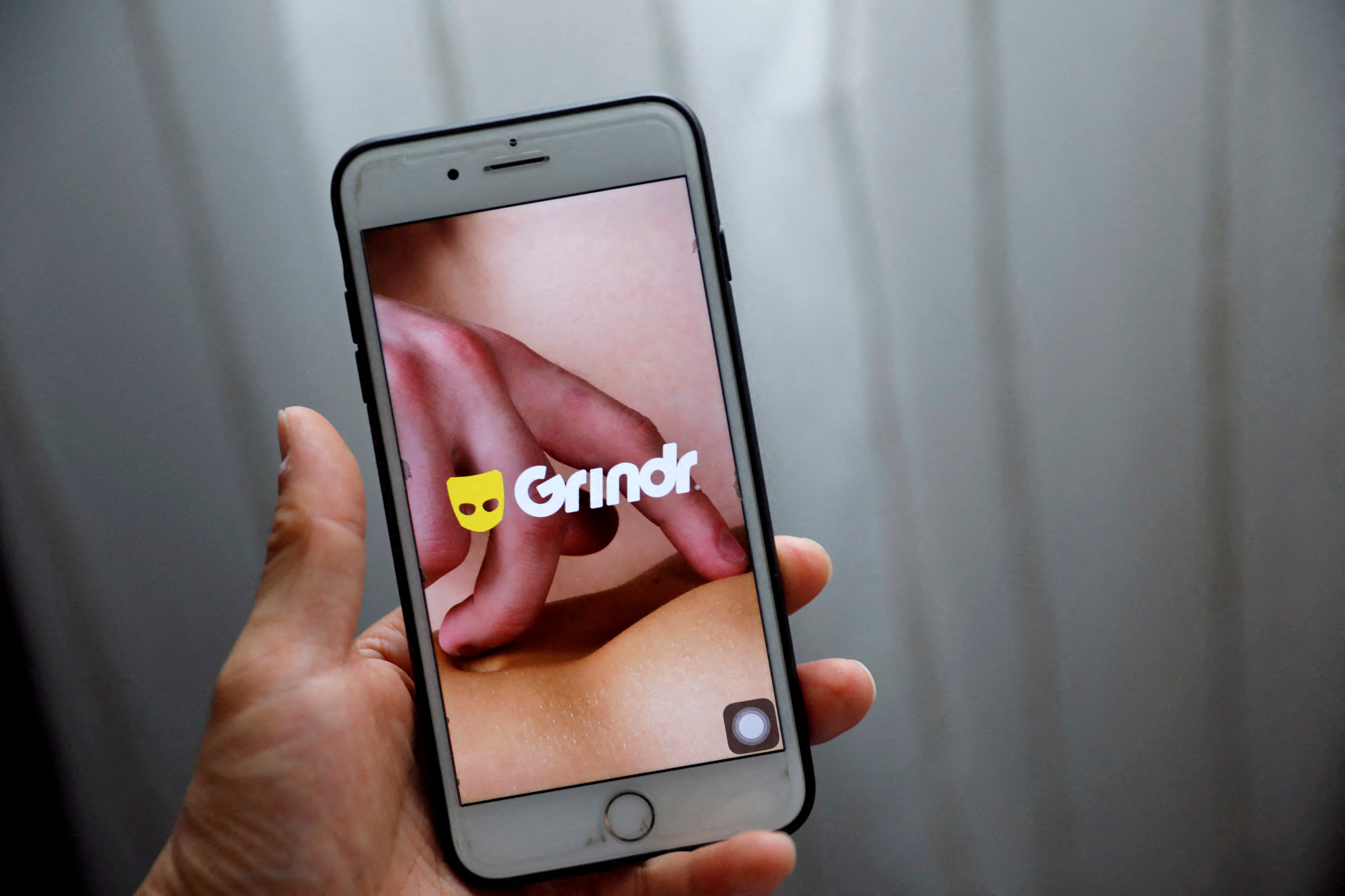Grindr app is seen on a mobile phone in this photo illustration