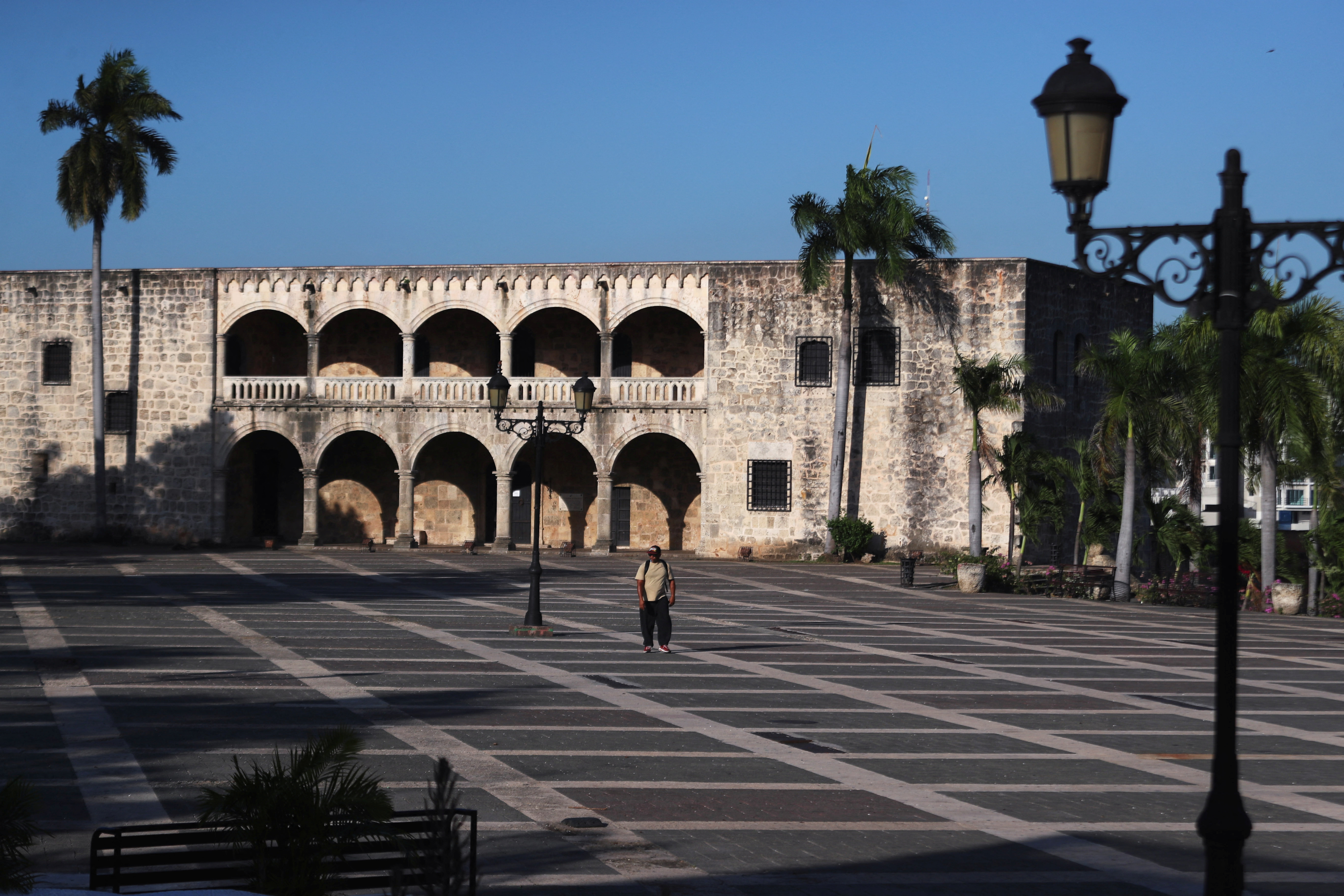 A man walks through the colonial zone, after state of emergency decreed by government  on last Thursday , as a preventive measure against the spread of the coronavirus disease (COVID-19), in Santo Domingo