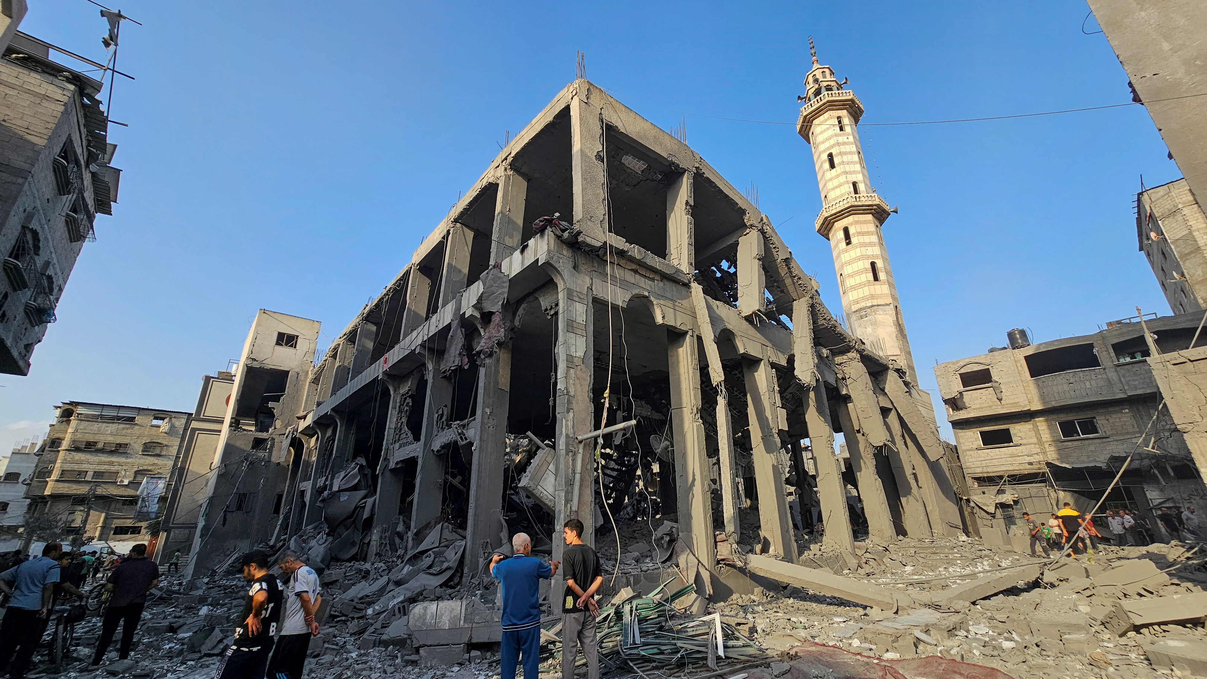 Palestinians inspect the ruins of a mosque destroyed by Israeli raids in the northern Gaza Strip