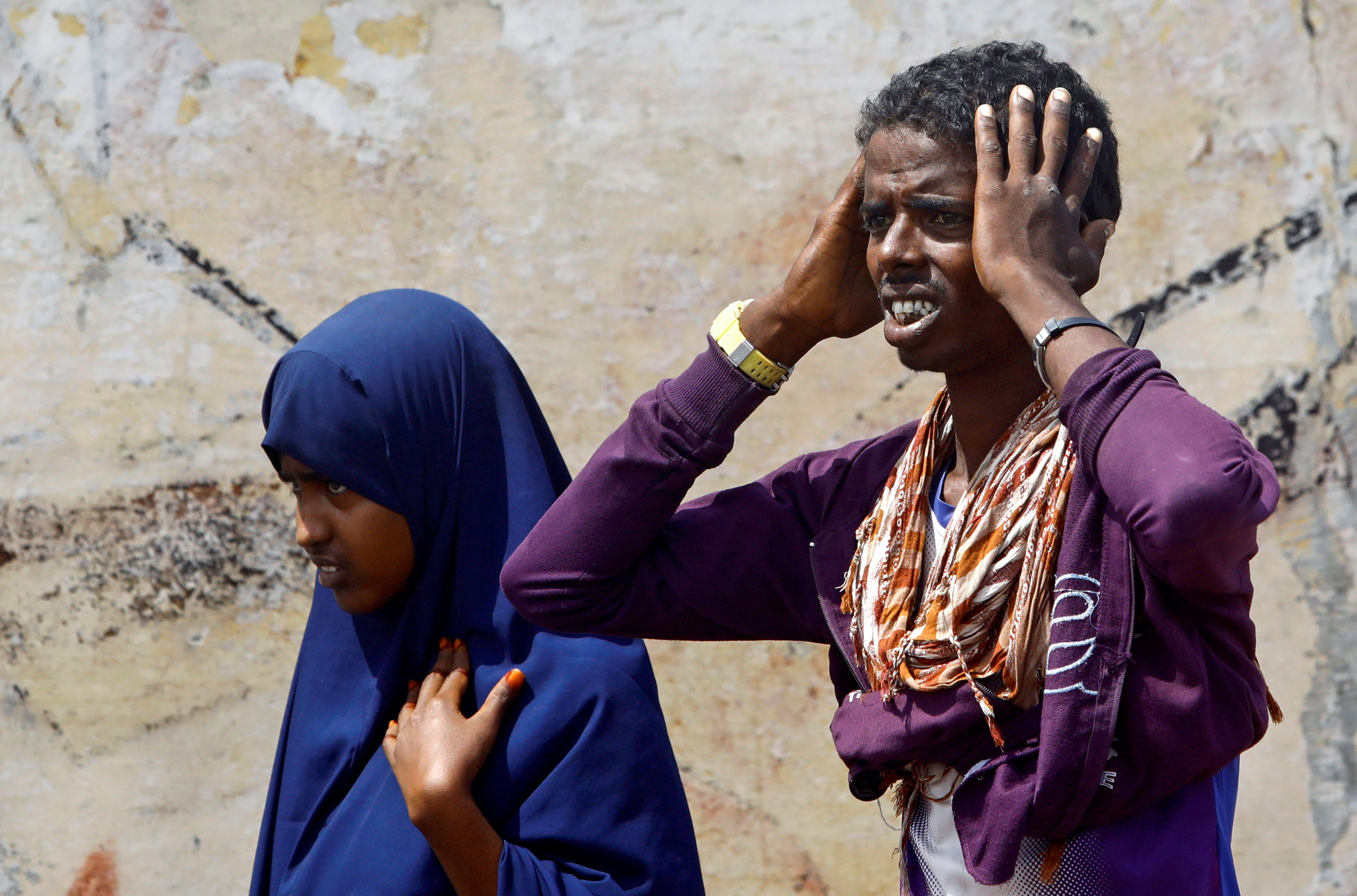 Residents react at the scene after a car explosion near Banadir hospital in Mogadishu, Somalia July 10, 2021. REUTERS/Feisal Omar