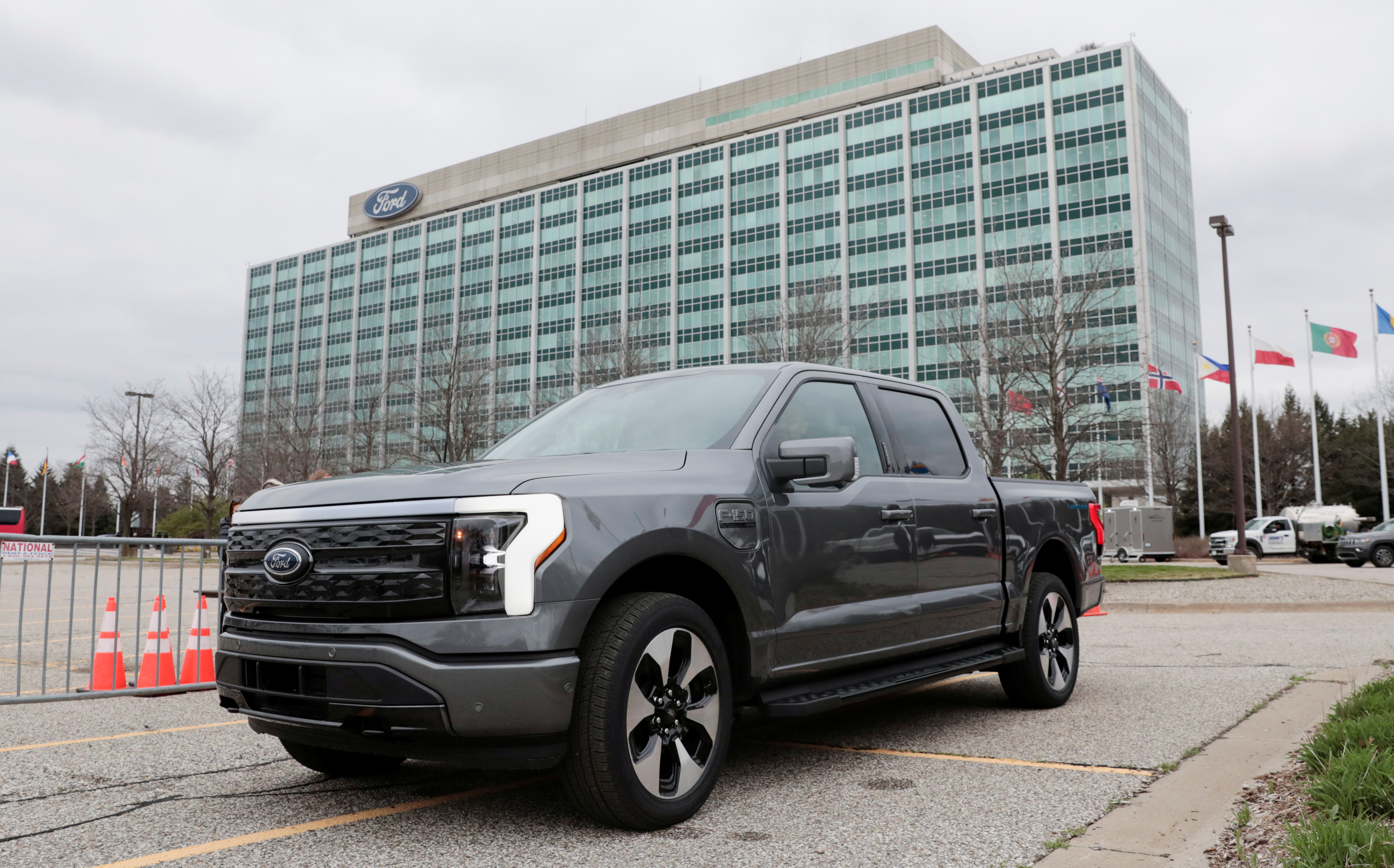 A model of the all-new Ford F-150 Lightning electric pickup is parked in front of the Ford Motor Company World Headquarters in Dearborn