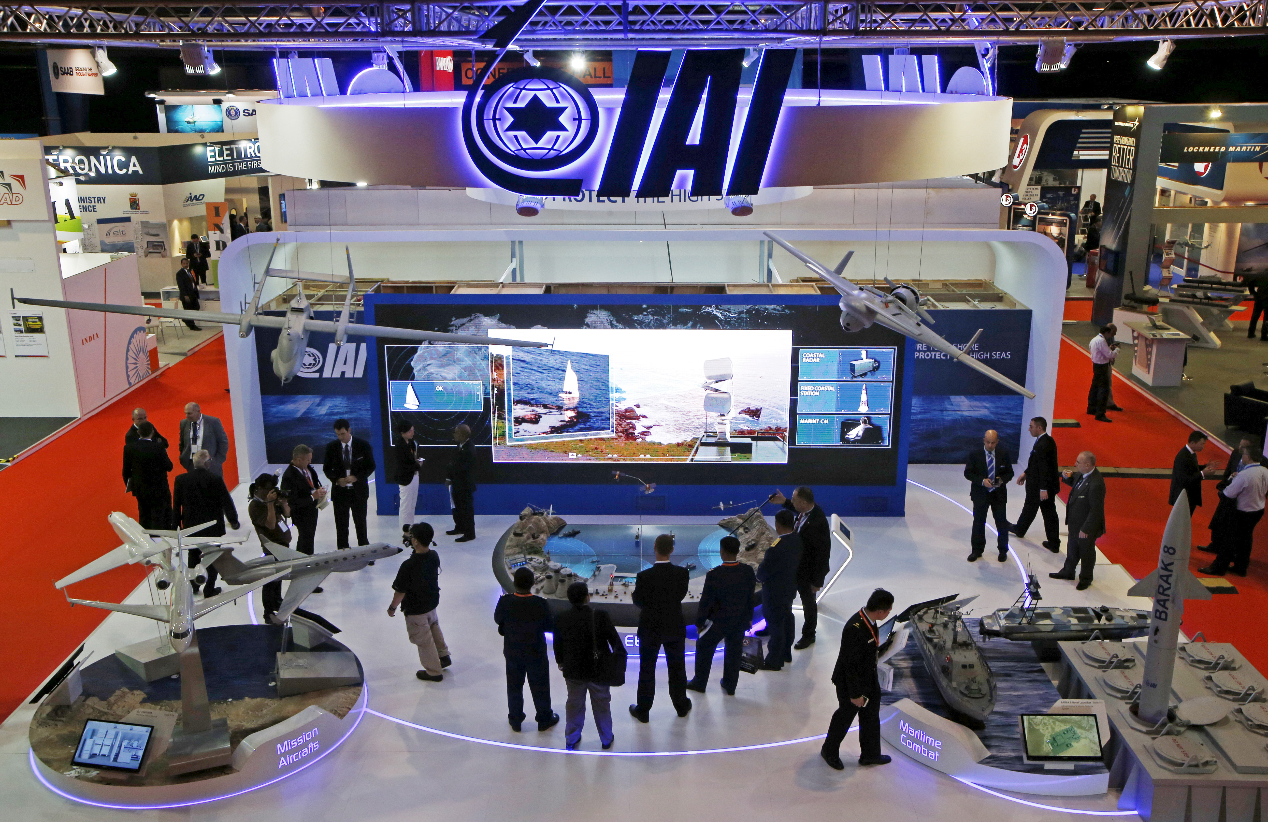 Visitors watch a demonstration at the Israel Aerospace Industries (IAI) booth in the IMDEX Asia maritime defence exhibition in Singapore