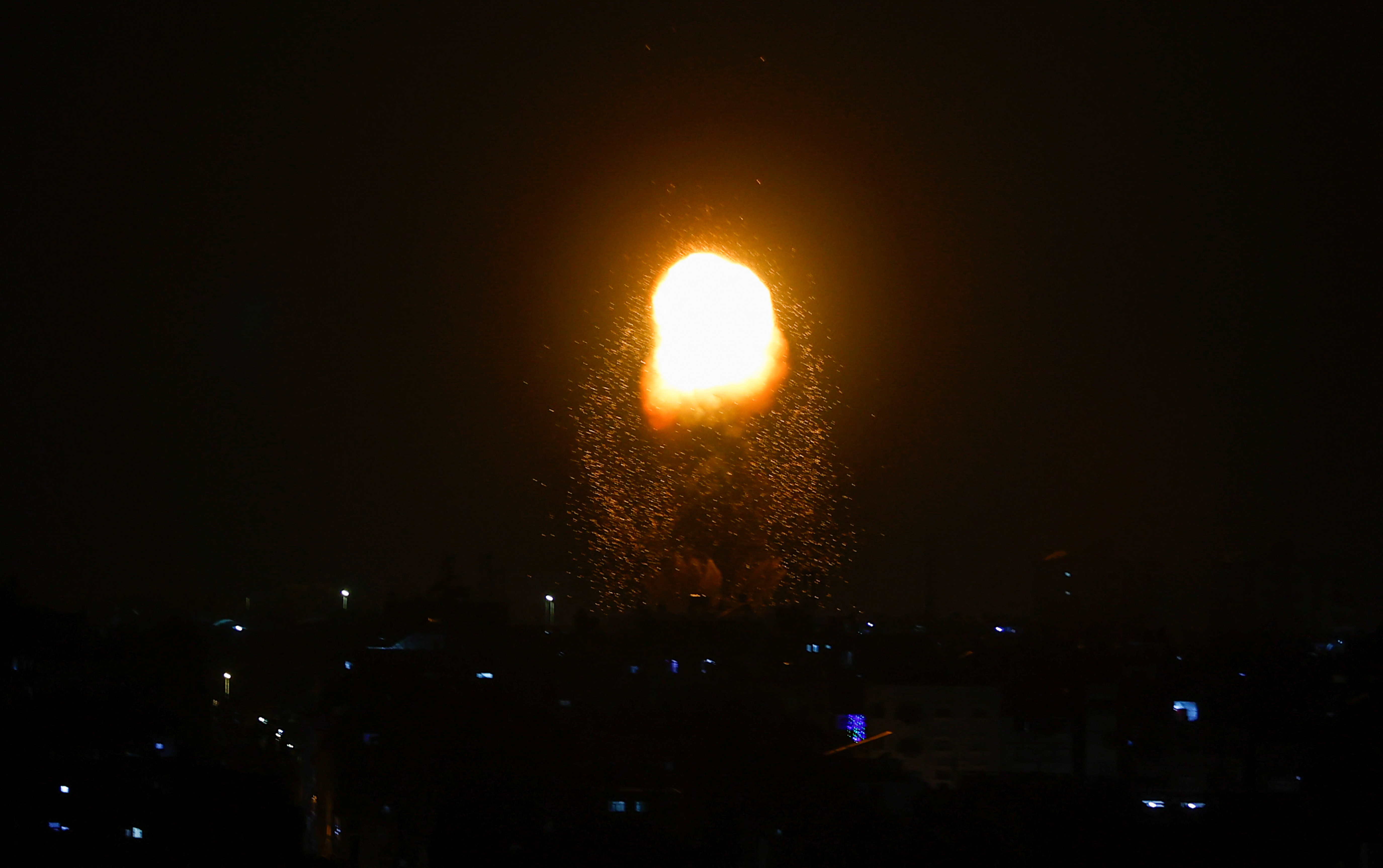 Flames rise, following an Israeli air strike in Gaza