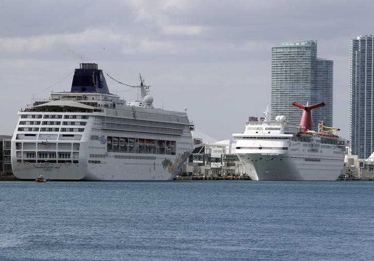 Cruise ships Carnival Imagination and Norwegian Sky sit docked at the Port Of Miami