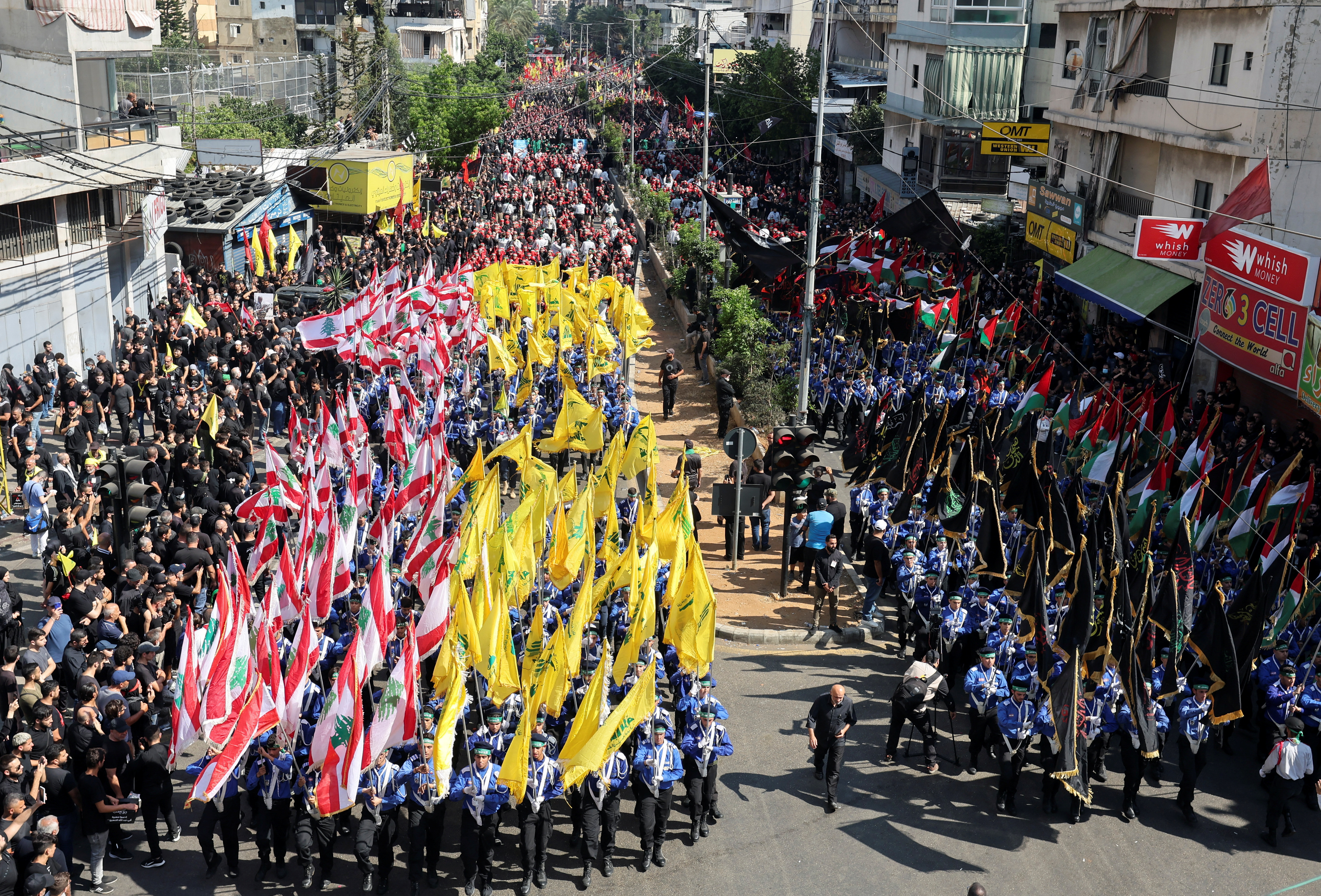 Lebanon's Imam al-Mahdi Scouts carry flags during a religious procession to mark Ashura in Beirut's suburbs