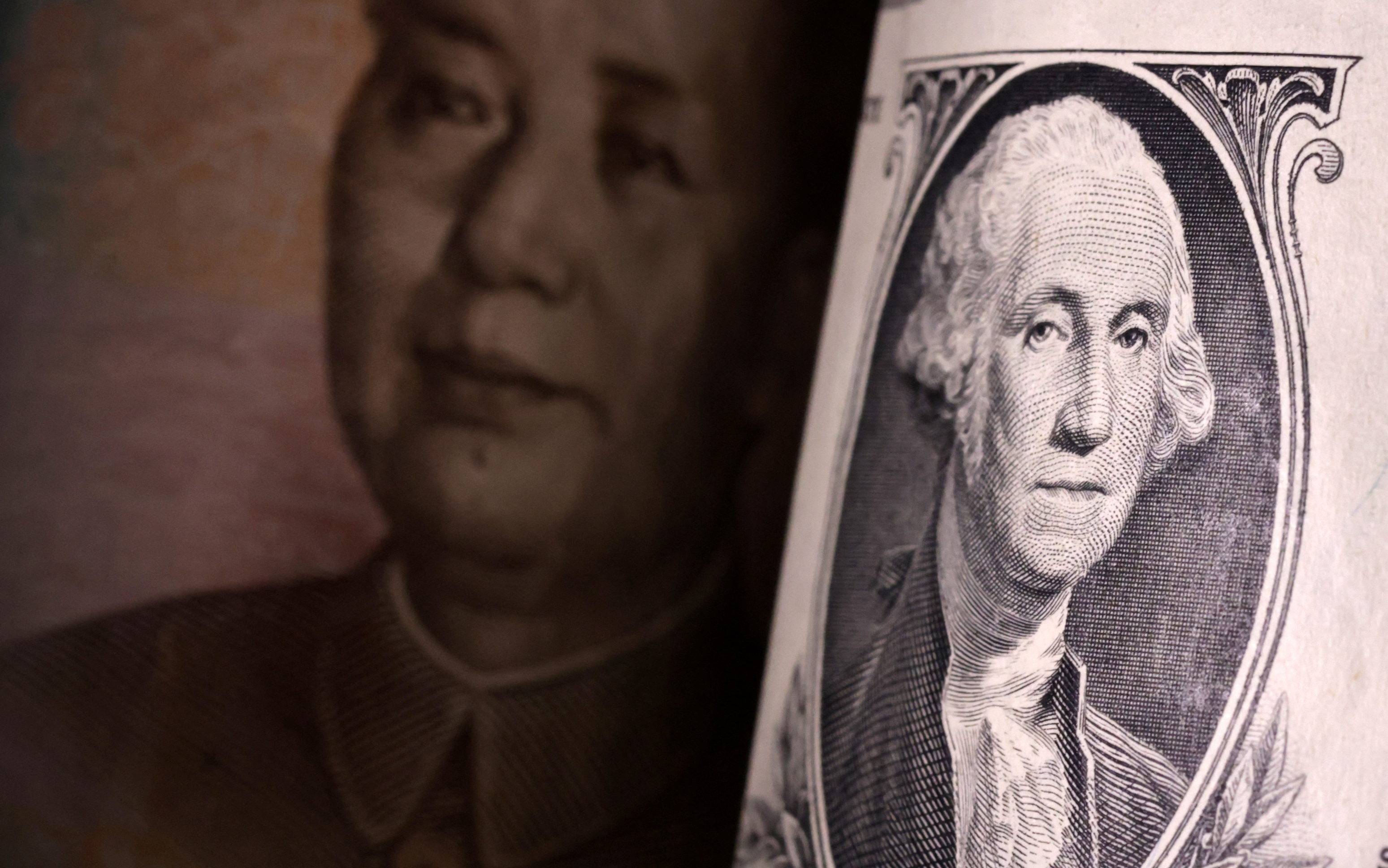 Illustration shows U.S. dollar and Chinese Yuan banknotes