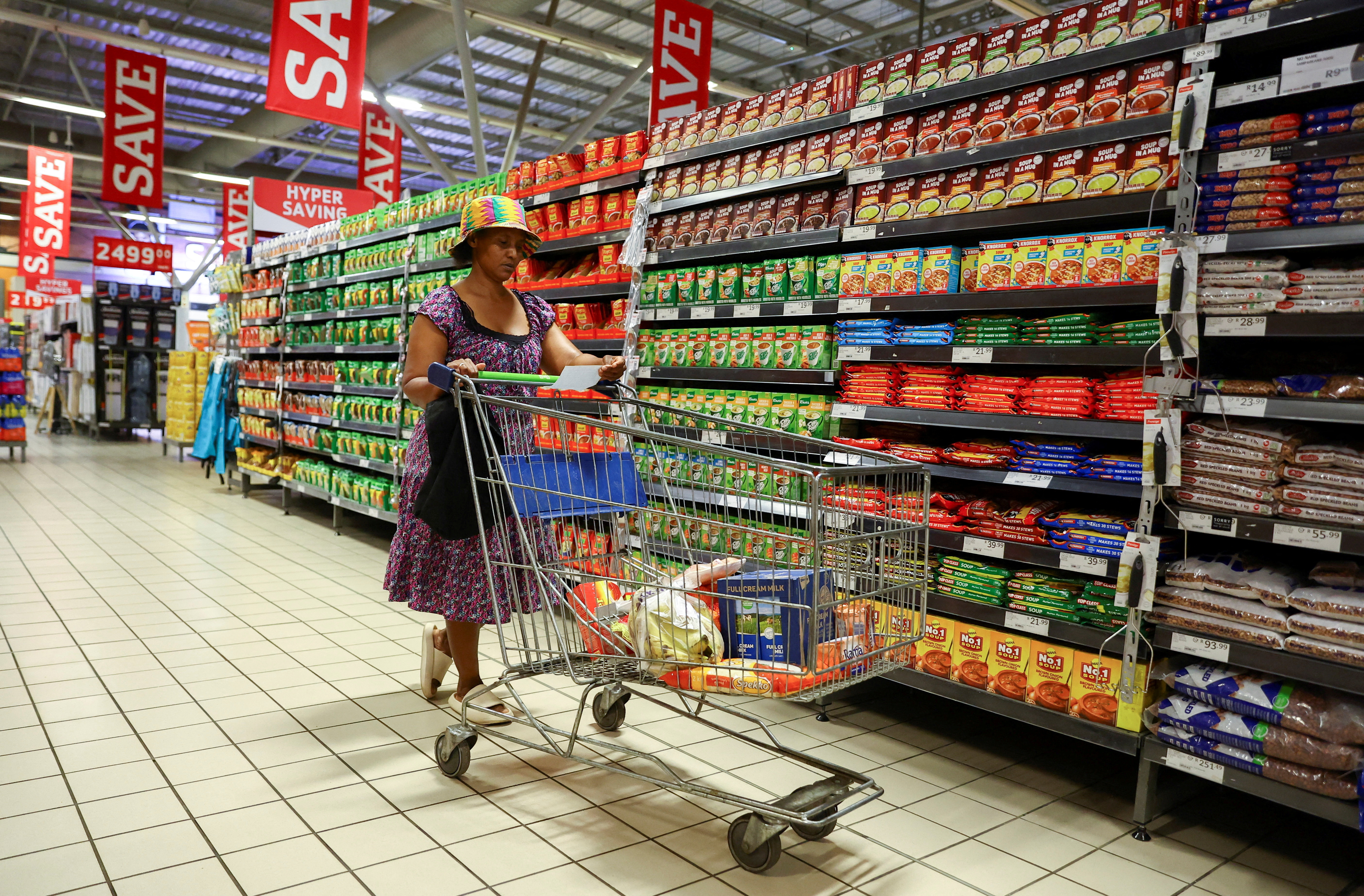 A woman uses a trolley as she shops at a Pick n Pay store