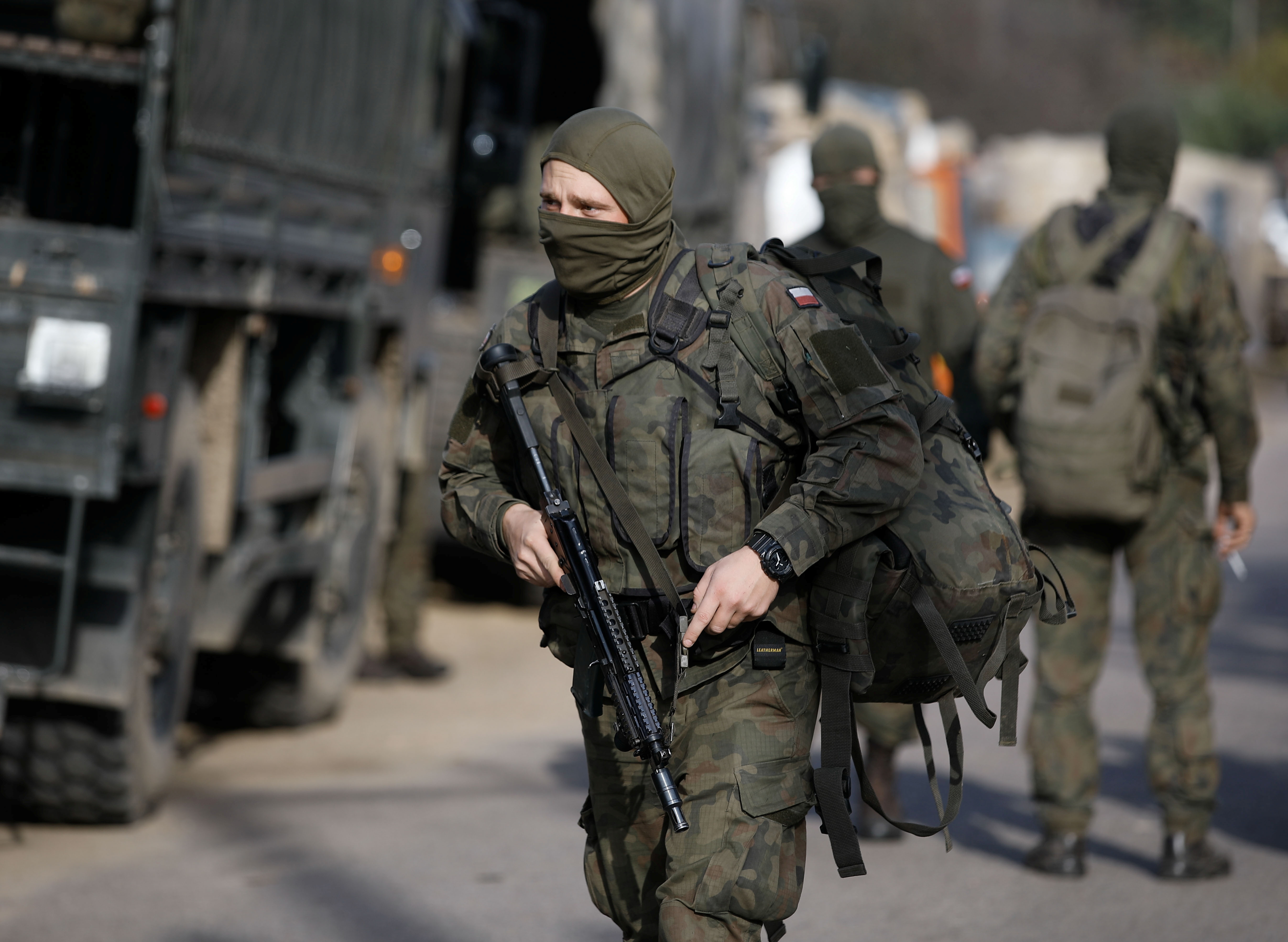 Polish Army soldiers are seen in front of the Border Guard headquarters in Michalowo