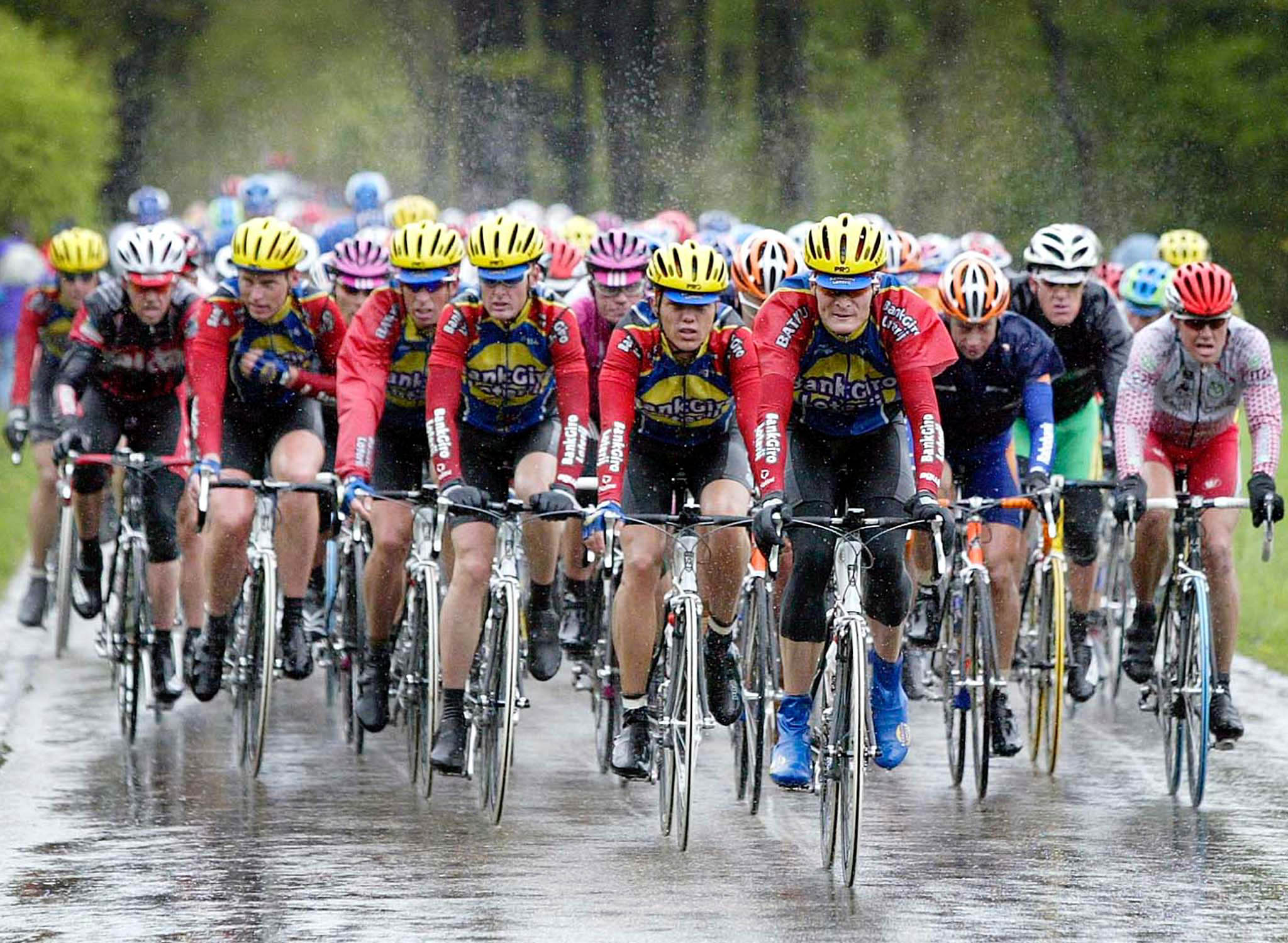 The Dutch cycling team of Bankgiro Batavus leads the pack in pouring rain just outside the town of G..