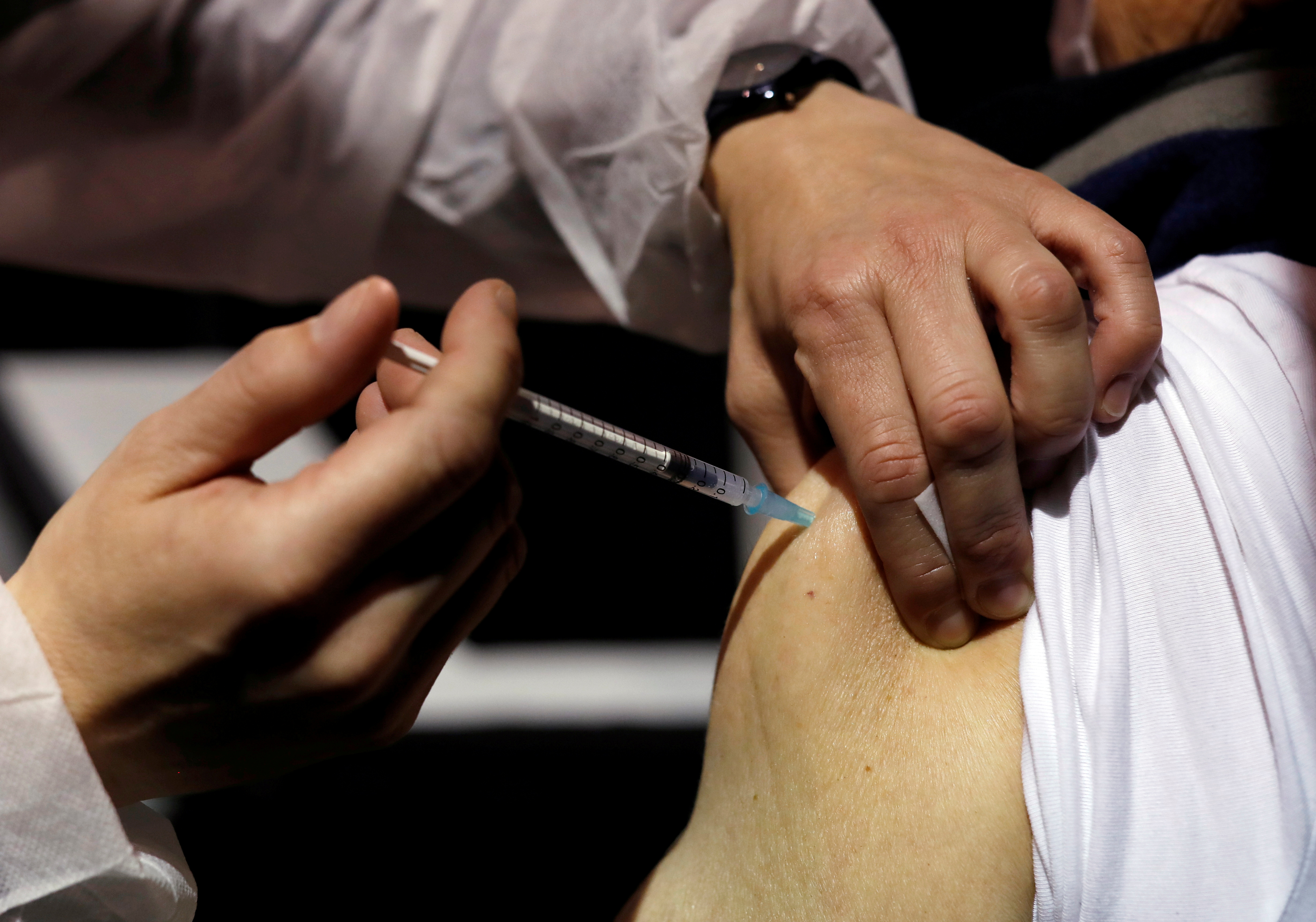 A senior citizen receives the Moderna coronavirus disease (COVID-19) vaccine at a vaccination center in Le Cannet, France, January 19, 2021.  REUTERS/Eric Gaillard/File Photo