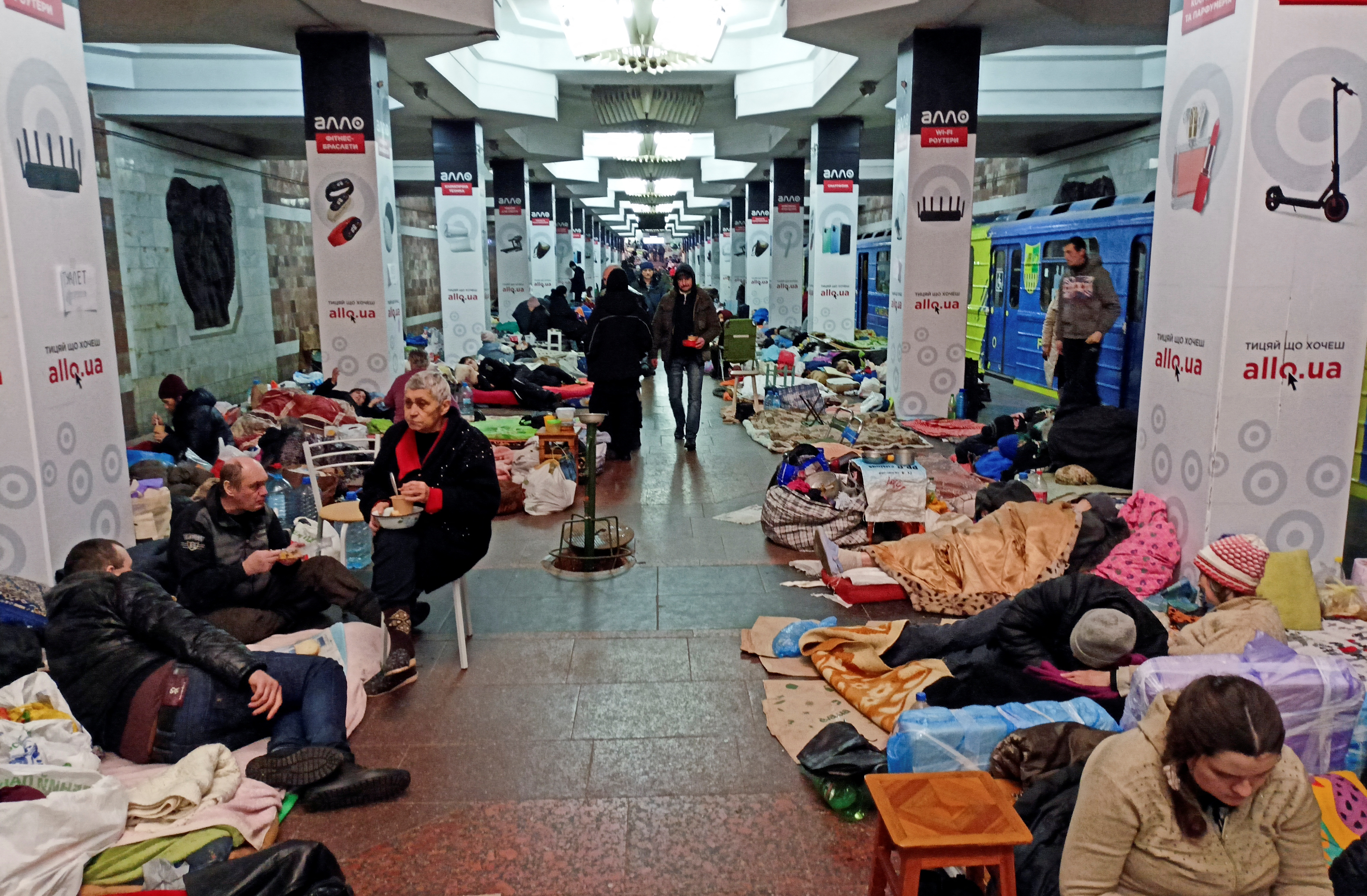 People shelter from shelling in a metro station in Kharkiv