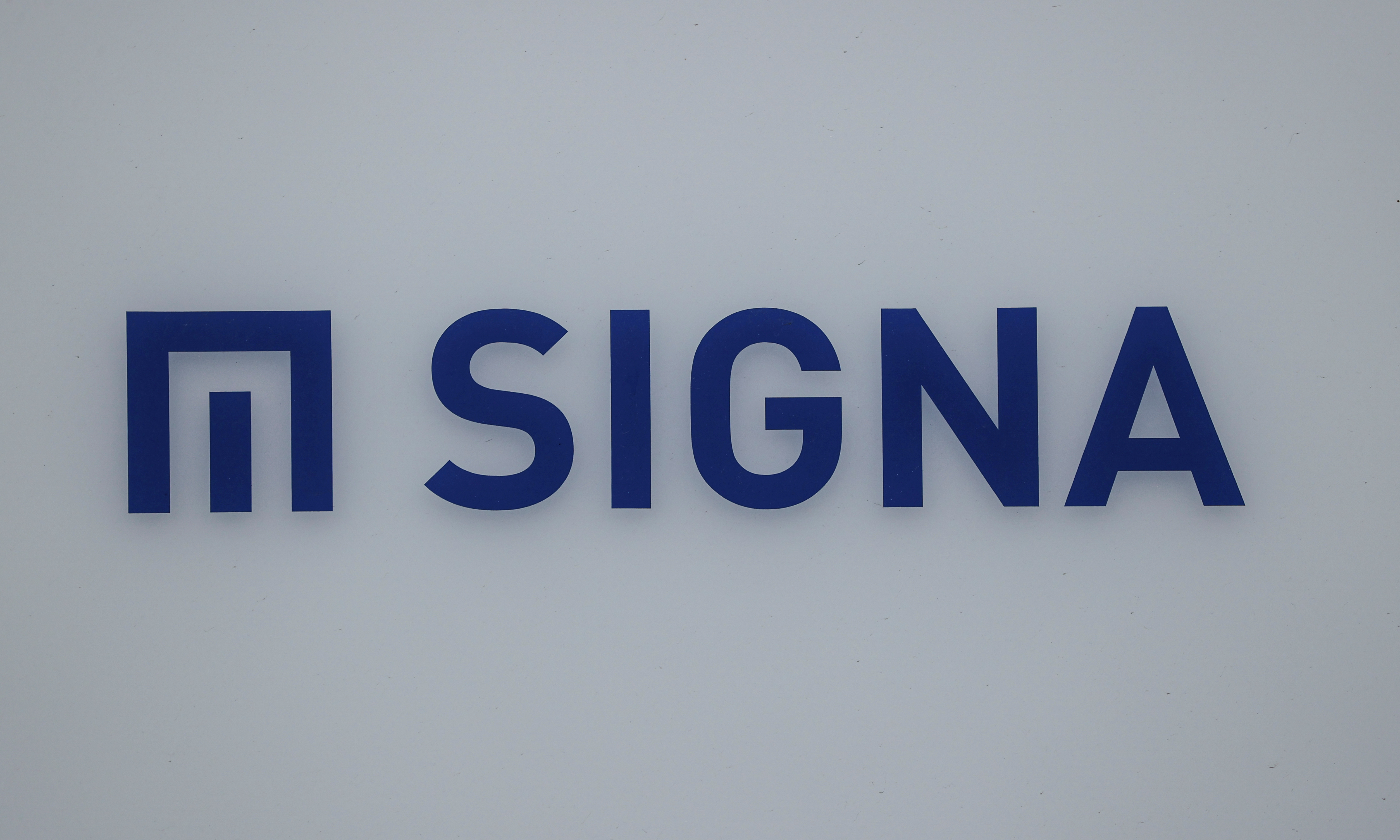 A logo of Signa is pictured on a building nearby the Karstadt sport department store, in Berlin