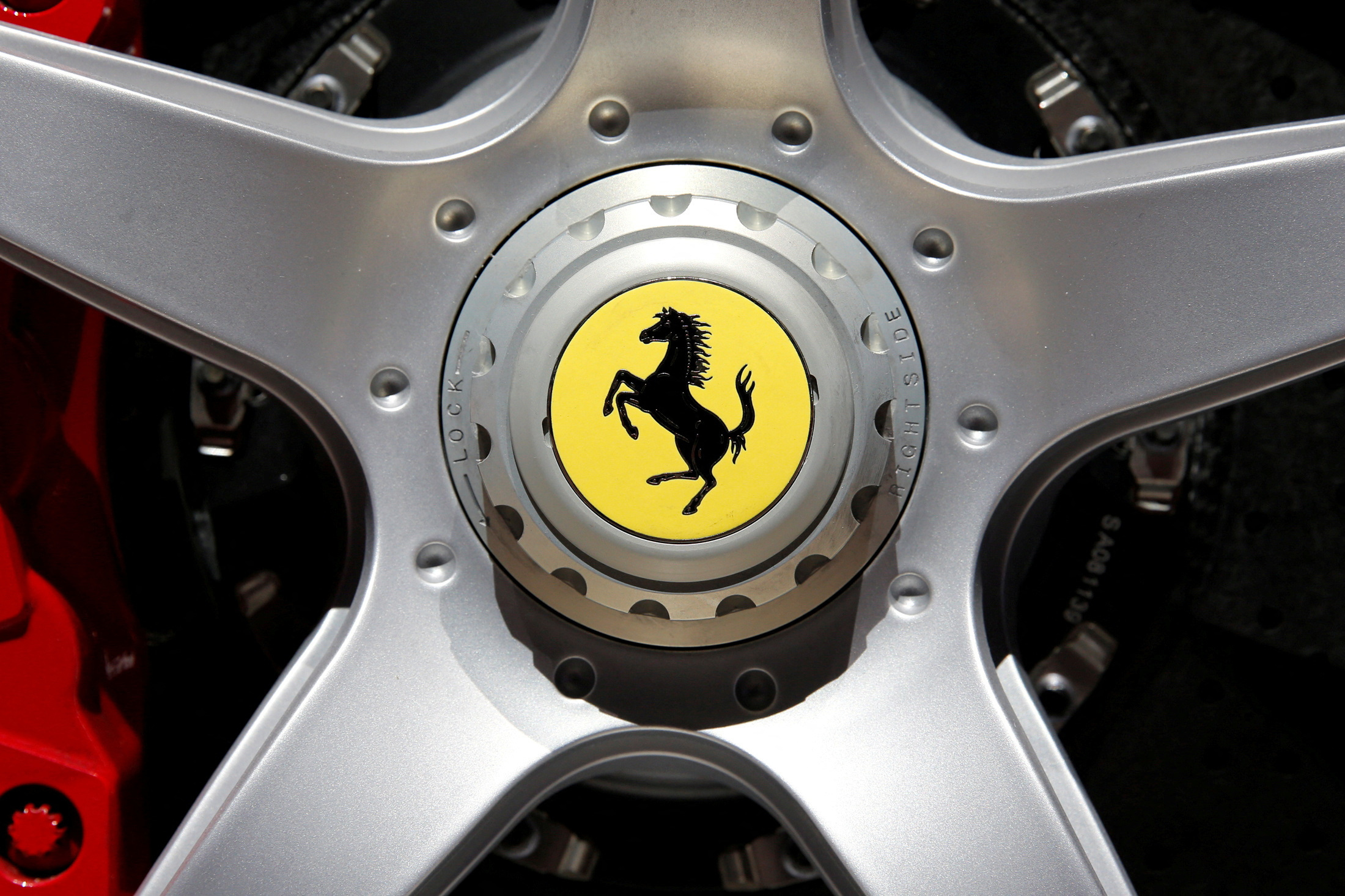 A Ferrari logo is seen on media day at the Paris auto show, in Paris