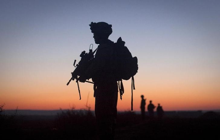 U.S. Marine Harris is silhouetted at dawn while on operation in the Garmsir district of Helmand Province
