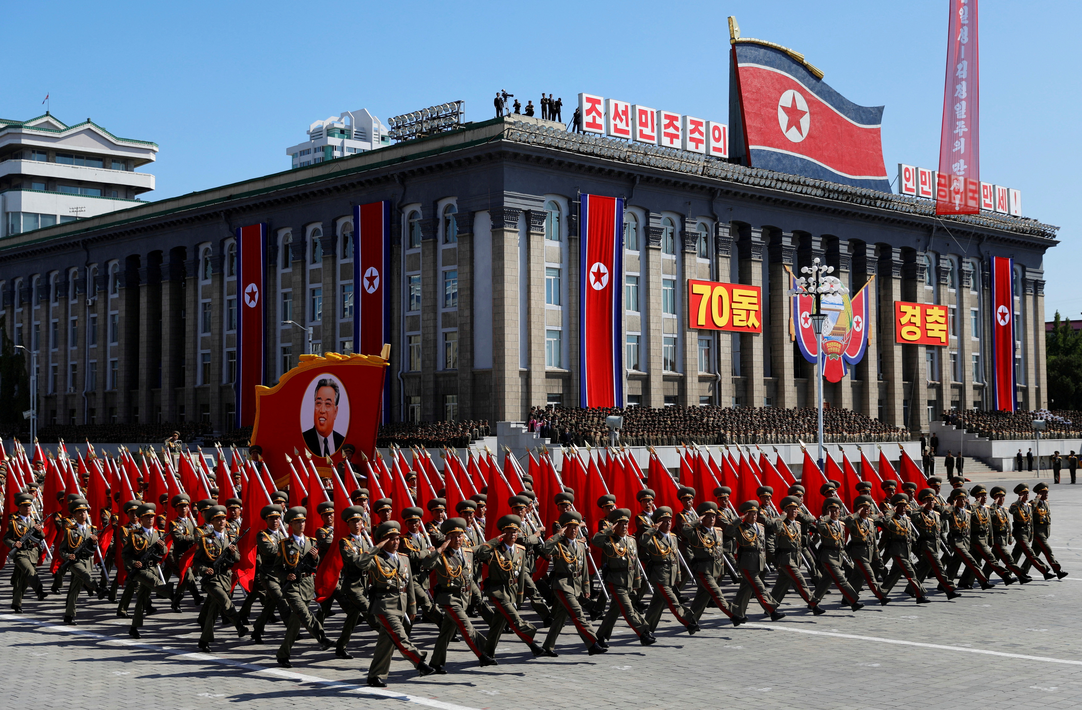 Soldiers march with the portrait of North Korean founder Kim Il Sung during a military parade marking the 70th anniversary of country's foundation in Pyongyang
