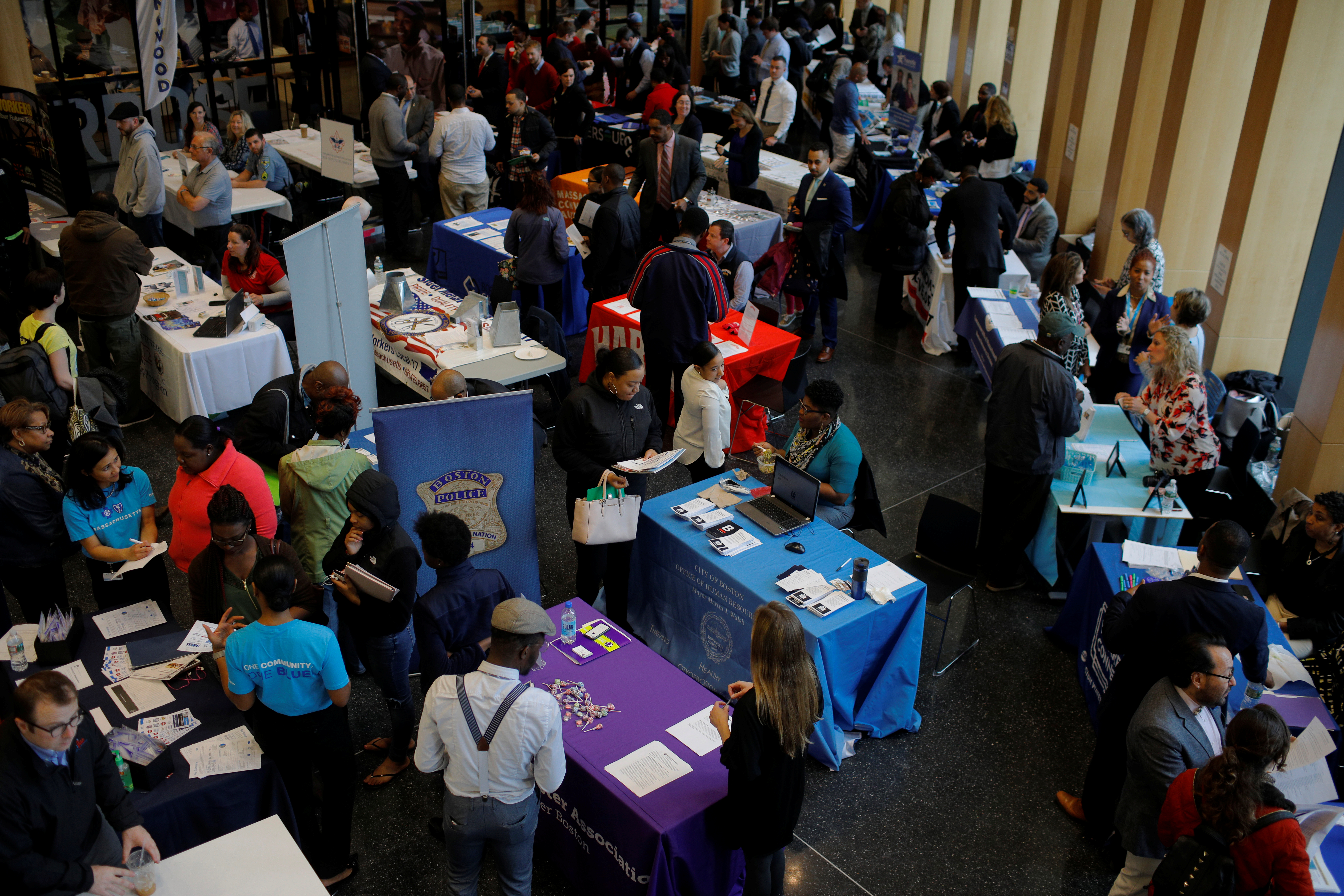 Job seekers speak with potential employers at a City of Boston Neighborhood Career Fair on May Day in Boston